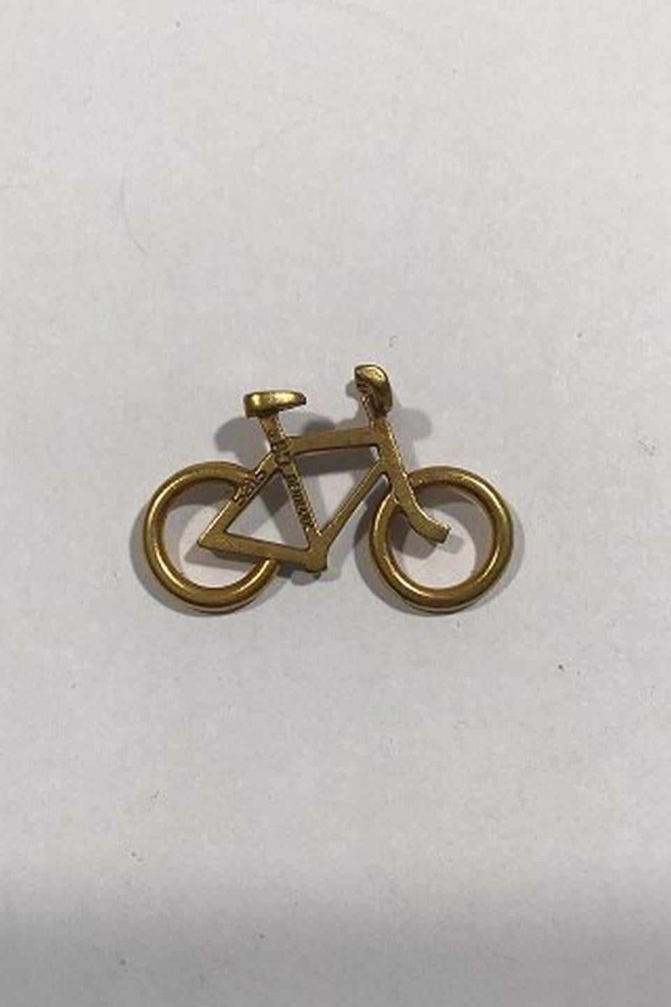 Georg Jensen Gilt Brass Men's Bicycle Pendant No 5215. 
Design by Ole Bent Petersen Measures 3 cm x 2 cm(1 3/16 in x 0 25/32 in) 
Weight 2.6 gr/0.09 oz
Item no.: 438460