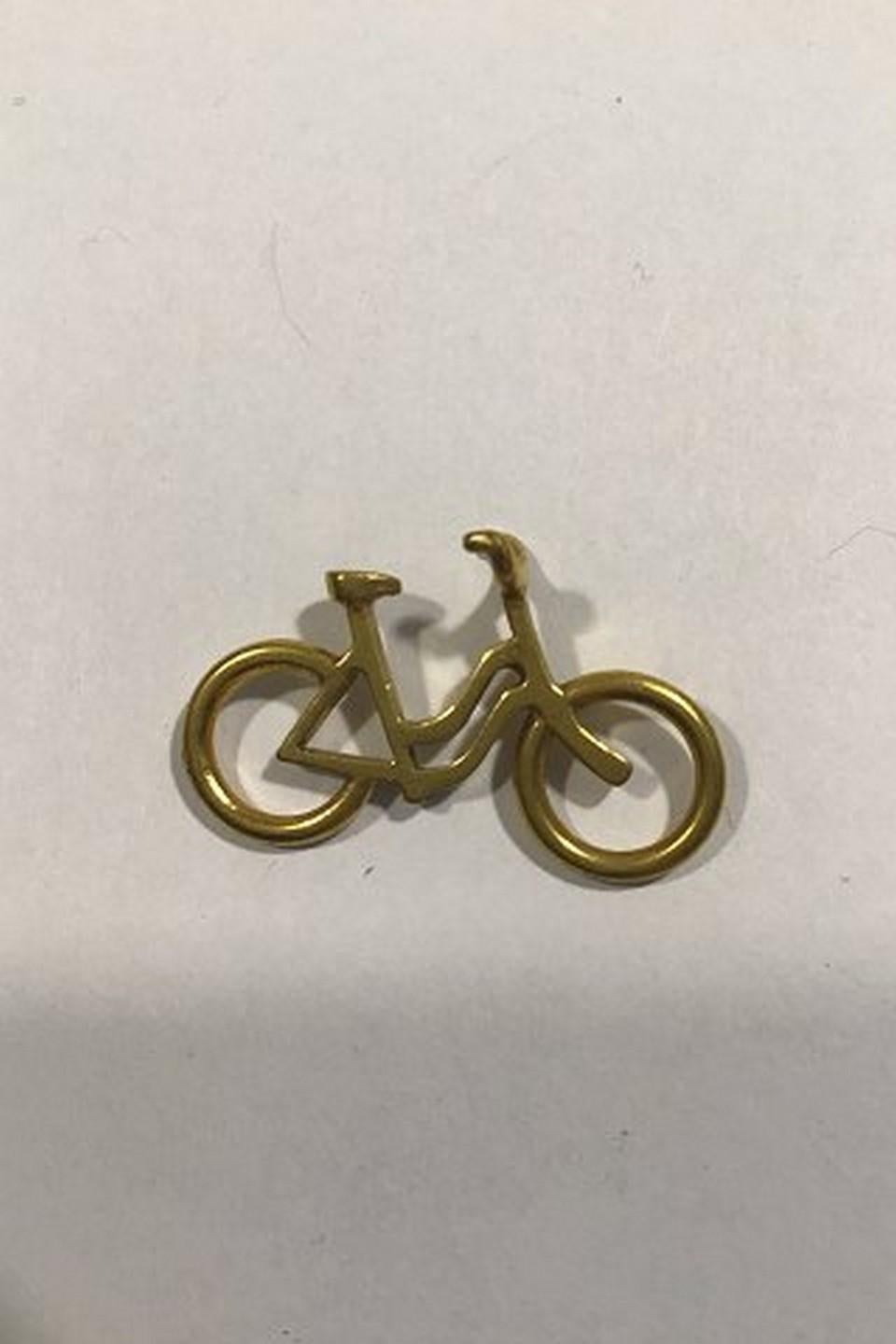 Georg Jensen Gilt Brass Woman's Bicycle Pendant 
Design by Ole Bent Petersen Measures 2.7 cm x 1.7 cm(1 1/16 in x 0 43/64 in) 
Weight 1.8 gr/0.06 oz (No hallmarks)
Item no.: 438461