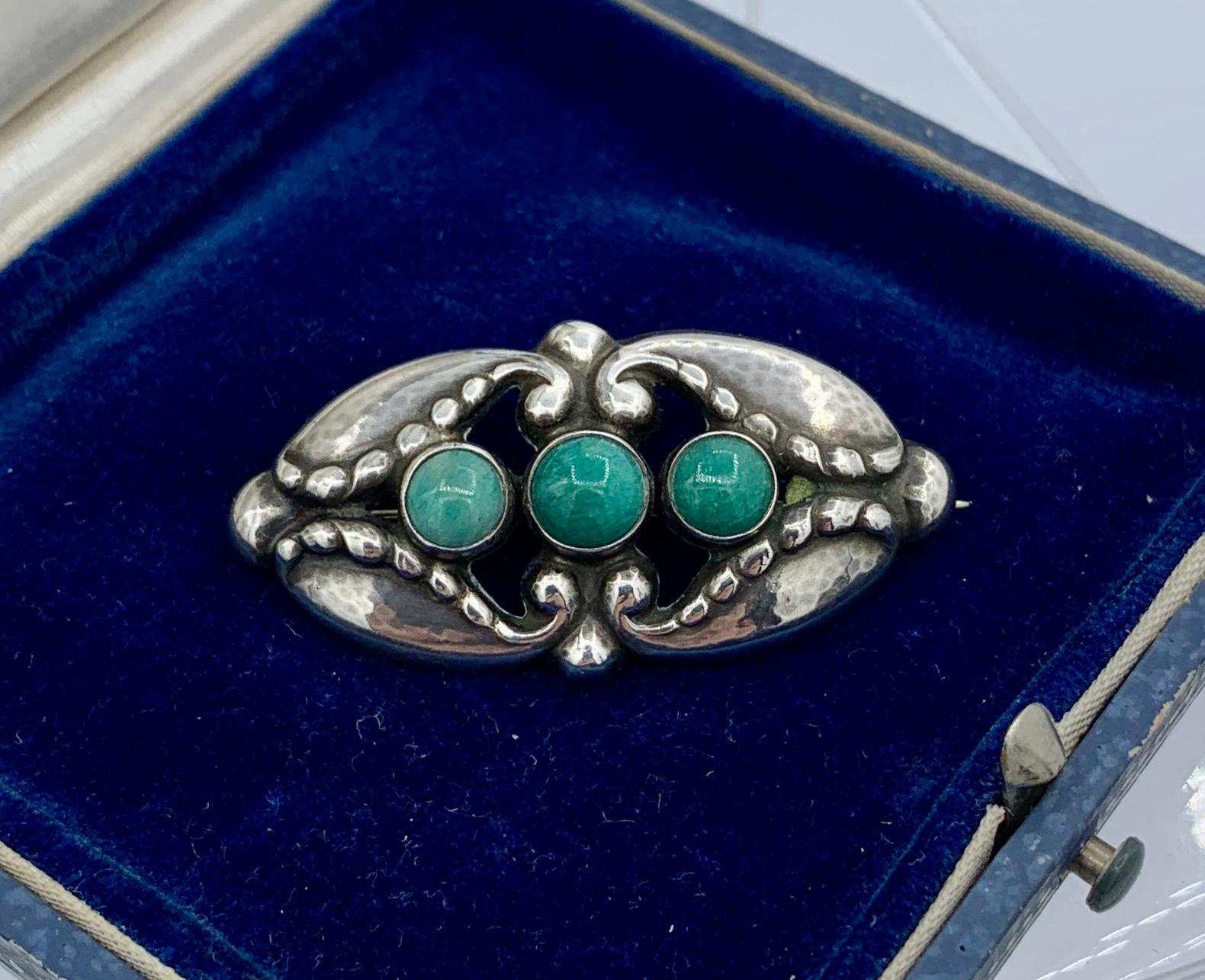 This is the rare Georg Jensen Brooch No. 156 with Green Agate.  This classic Jensen sterling silver brooch with cabochon green agates was designed by personally by Georg Jensen. Finding Jensen pieces with stones is always a delight and this iconic