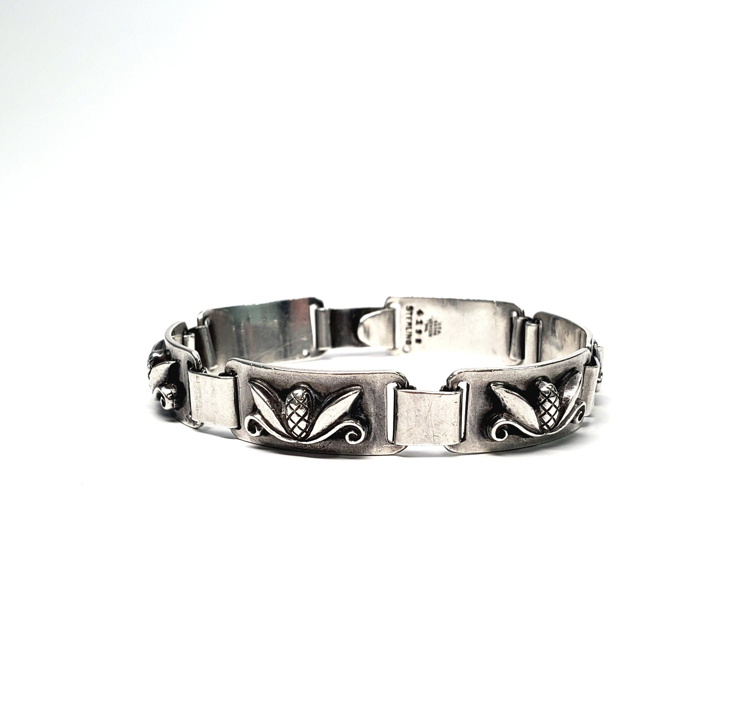 Vintage Laurence Foss for Georg Jensen Inc. USA sterling silver pine cone link bracelet. A highly collectible and rare piece, circa 1950. Bracelet consists of 6 rectangular links, each with an applied pine cone motif, joined by thick loops, with a