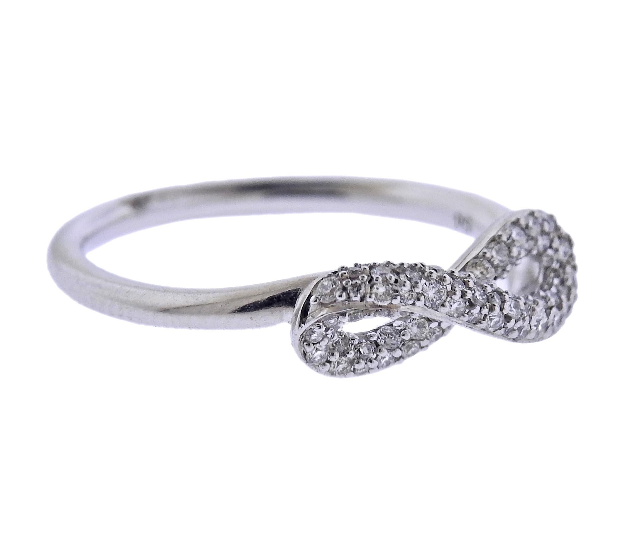 Brand new Georg Jensen sterling silver ring from Infinity collection, with approx. 0.24ctw G/VS diamonds. Marked: GJ mark, 925 S. Top of the ring is 6 x 15mm. Available in sizes: 54, 53, 51, 55, 52. Model # 3560440. Weight - 2.1 grams.