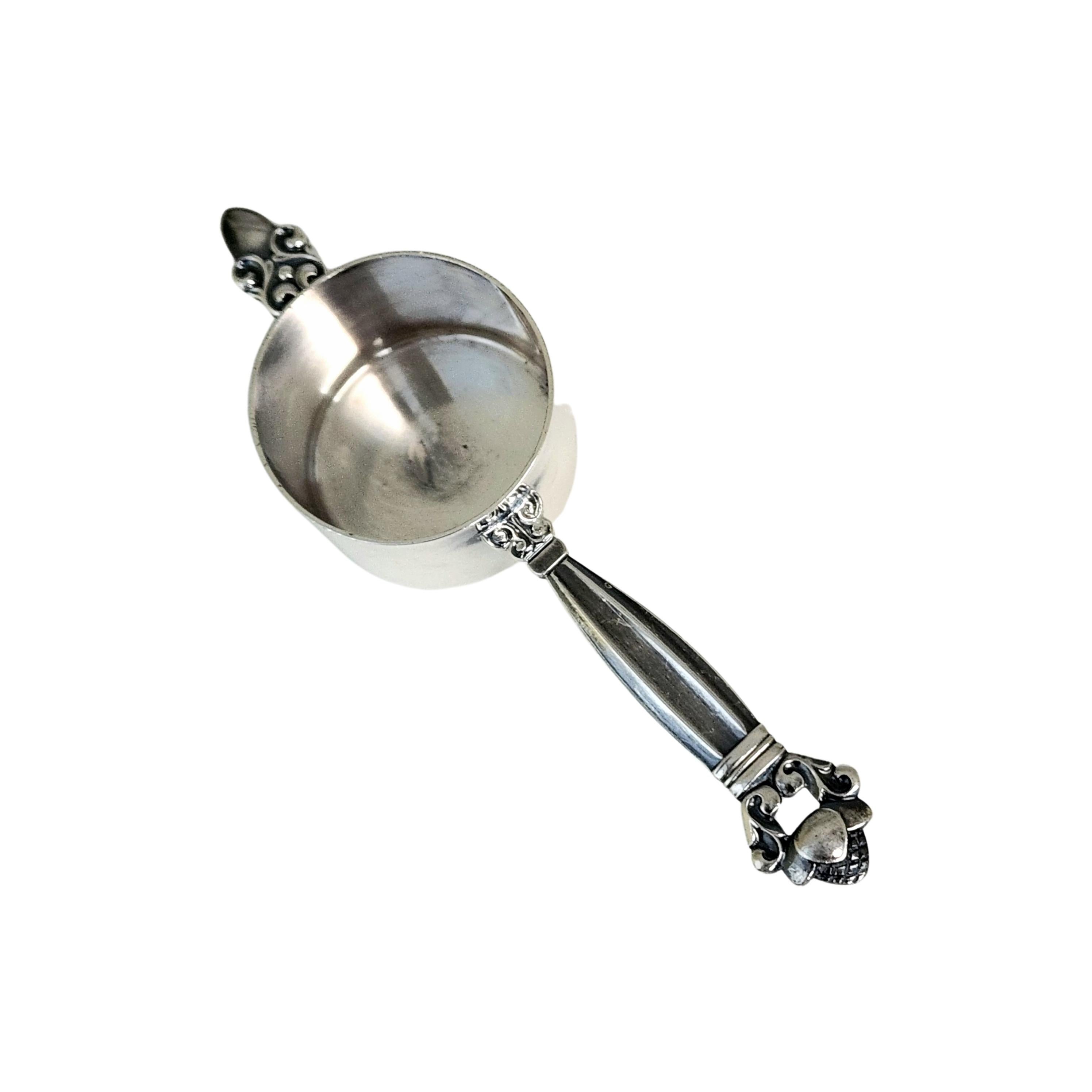 Sterling silver drink measurer jigger #662 in the Acorn pattern designed by Johan Rohde for Georg Jensen of Denmark.

The Acorn pattern was introduced in 1915 as a collaboration between Georg Jensen and designer Johan Ronde. The Acorn pattern, which