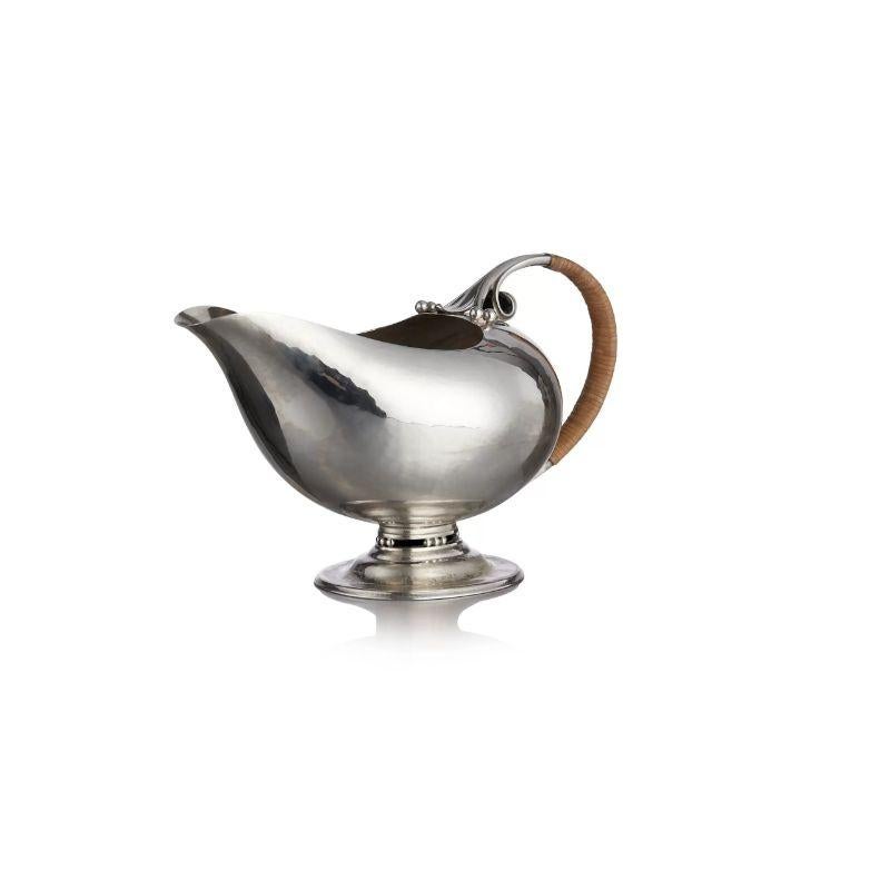 A rare and early Georg Jensen silver sauce boat, design #304 by Johan Rohde from 1919. Modern for its design year this elegant slightly hammered sauce boat has signs of early Art Deco design. Designed the same year of Rhode’s famous #432 pitcher