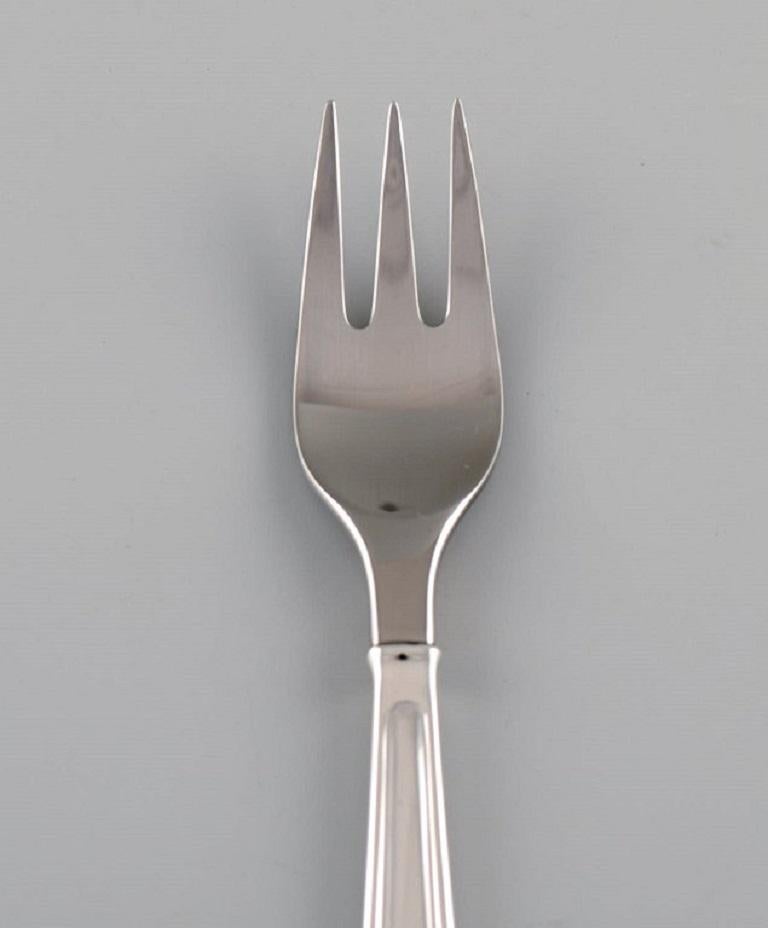 Rare Georg Jensen Koppel cutlery. Lunch fork in sterling silver and stainless steel. 
20 forks are available.
Length: 15.7 cm.
In excellent condition.
Stamped.
Designed by Henning Koppel in 1981.
Our skilled Georg Jensen silversmith /
