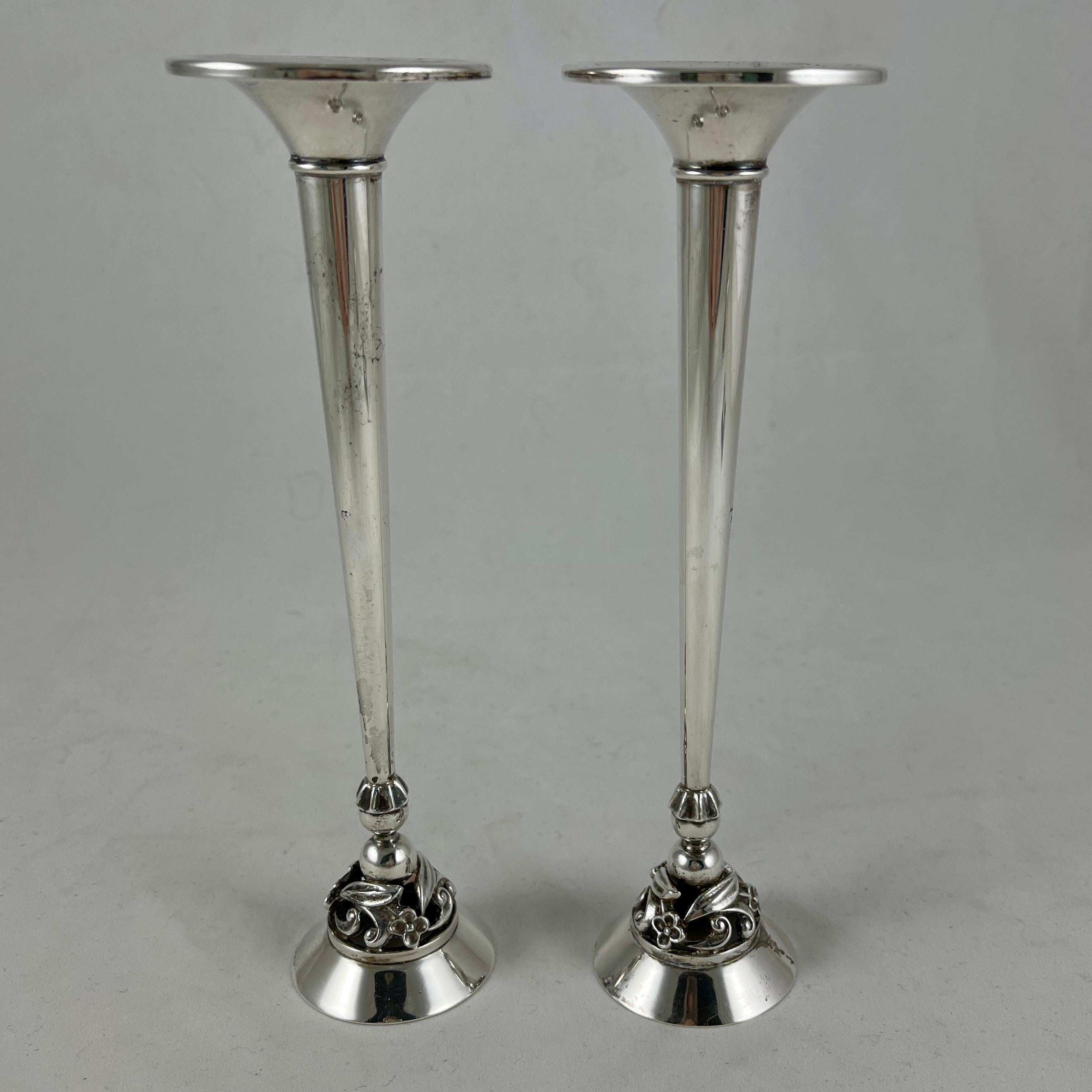 A pair of mid-century sterling silver modernist candlesticks showing the mark for Alphonse La Paglia, circa 1943 – 1950.

Alphonse La Paglia (1907-1953) was born in Sicily and studied silversmithing under Georg Jensen in Denmark. He was a designer