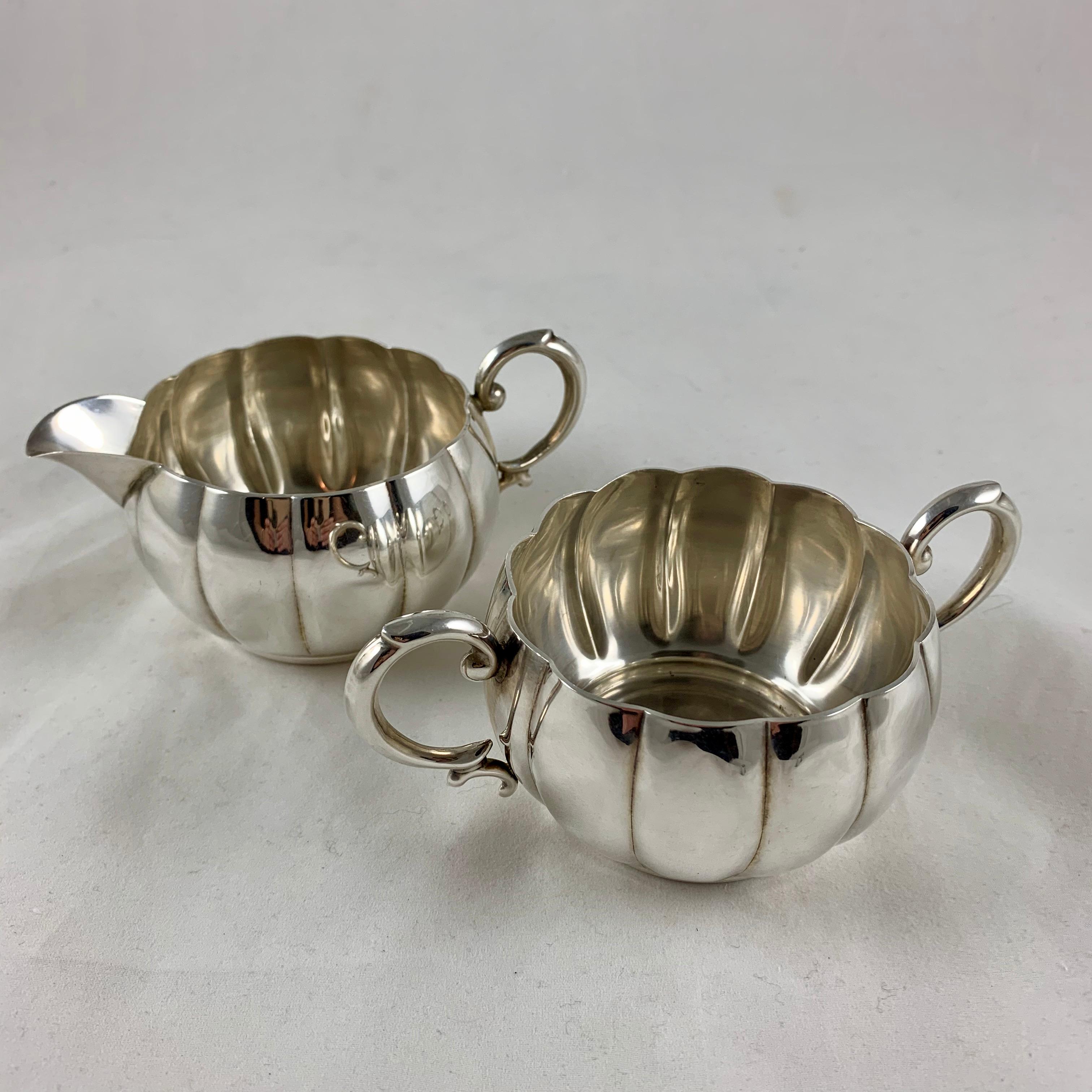 A midcentury sterling silver hollow ware cream and sugar set showing a mark attributed to Alphonse La Paglia, circa early 1940s.

La Paglia (1907-1953) was born in Sicily and studied silversmithing under Georg Jensen in Denmark. He was a designer