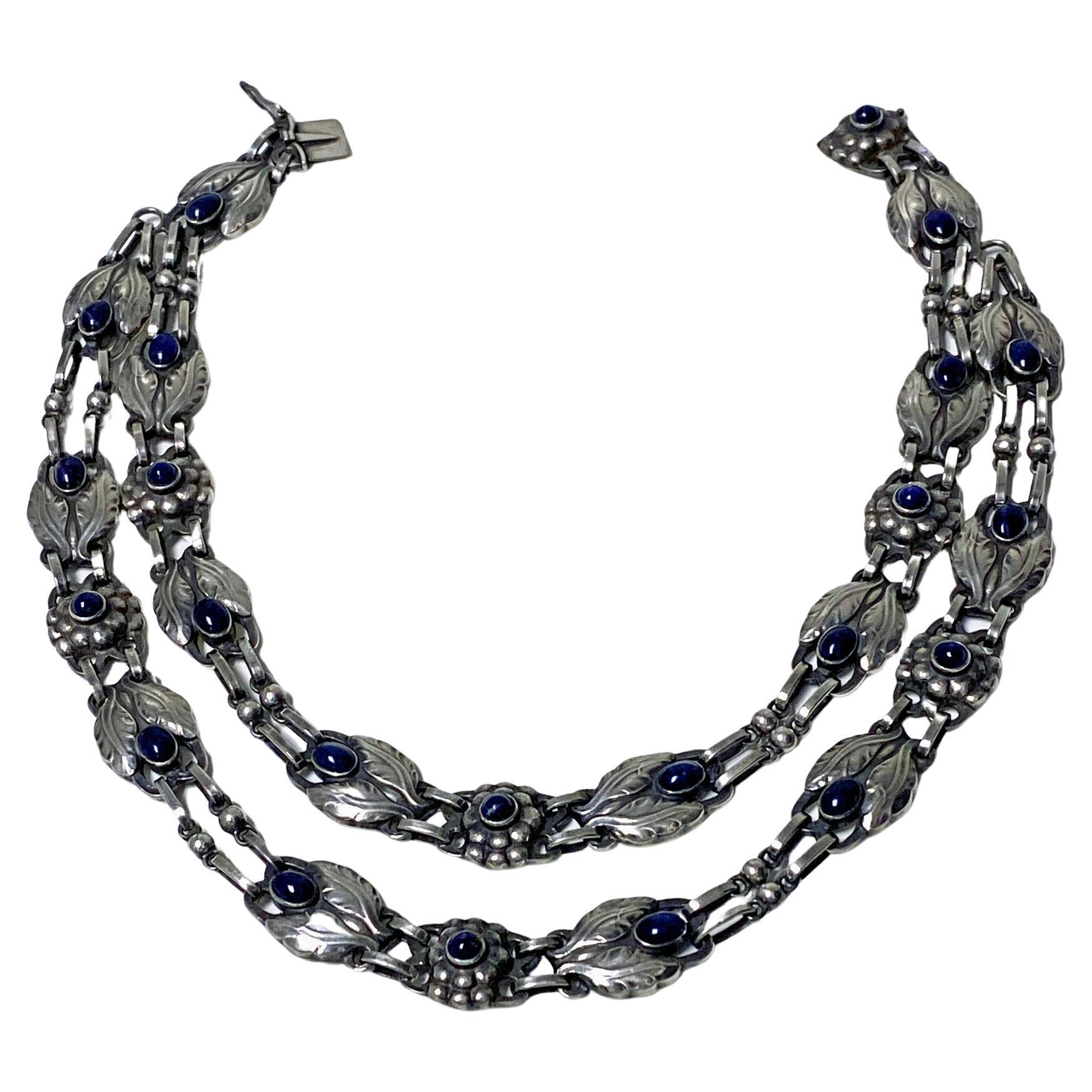 Very rare collectors piece Georg Jensen Lapis and Sterling Silver Necklace, double strand graduated strand design No 1, C.1933. Bezel set oval and round lapis with stylised bud leaves and berries interval links. Full Jensen marks and GI marks to