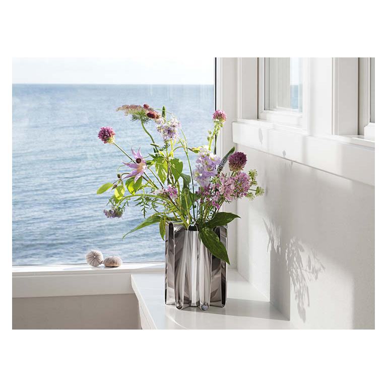 Striking and modern, the Frequency vase is a bold and dramatic addition to any living space, indoors or out. Inspired by the power of the ocean, designer Kelly Wearstler transformed hard shiny stainless steel into an undulating form that evokes both