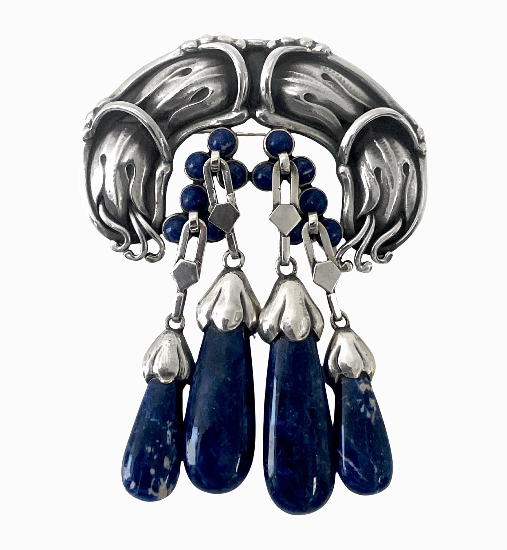 Important Georg Jensen large, rare Silver Lapis Lazuli Master Brooch, C.1930. Georg Jensen. Designed as elaborate foliate and bud motifs set with and suspending lapis lazuli cabochons and drops, no. 22, 9.00 cm, width 6.5 cm. Item Weight: 62 grams.