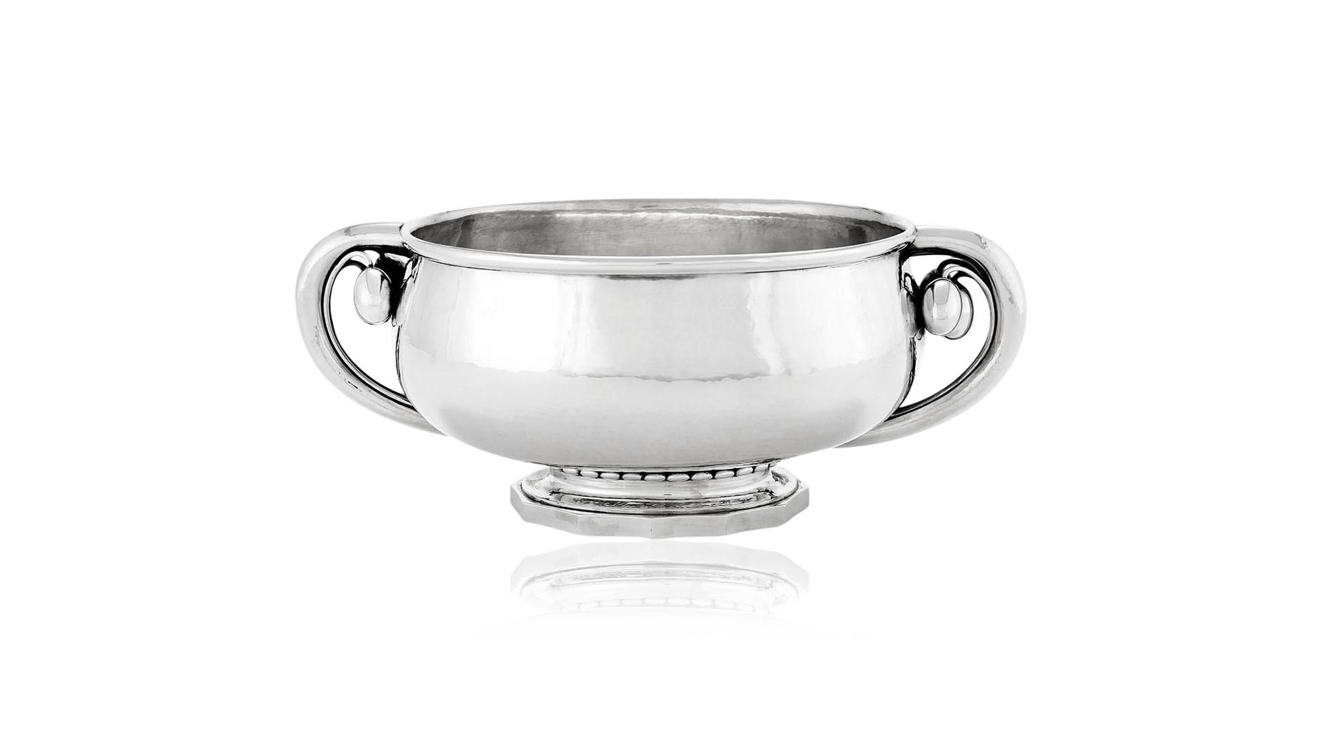 A large and heavy sterling silver Georg Jensen oval “Cherry” centerpiece bowl. This is one of Georg Jensen’s later designs, from a brief period in 1925-1926 when he lived in Paris. The bowl is a heavy thick oval shape that bulges out at the side and