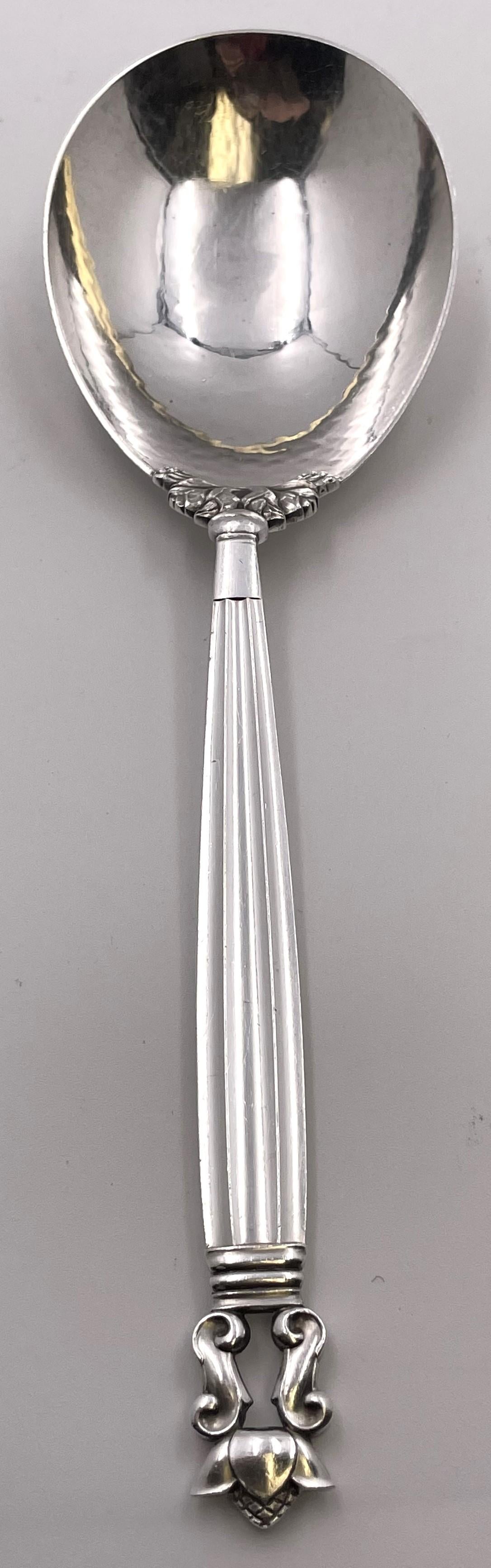 Georg Jensen sterling silver mashed potato spoon, with a hammered bowl, in the celebrated Acorn pattern. It measures 10'' in length and bears hallmarks as shown.

Danish silversmith Georg Jensen (1866-1935) set up his own silver business in 1904 in