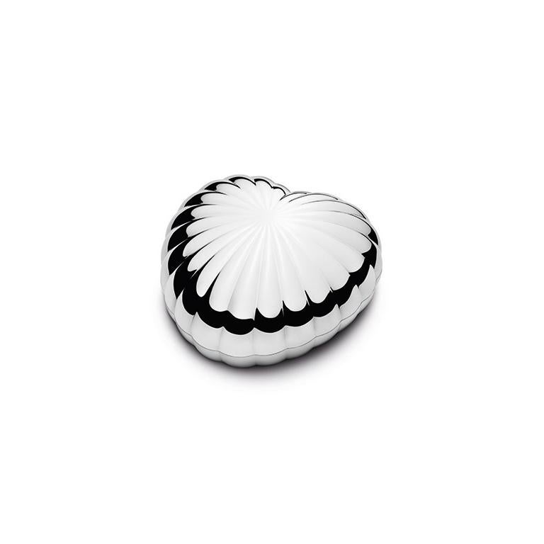 Few things are more viscerally pleasing than the curvaceous, instantly recognisable heart shape. As a box, it practically begs to be picked up, touched and opened. The shiny, scalloped chromium-plated surface forms a beautiful reflection. The