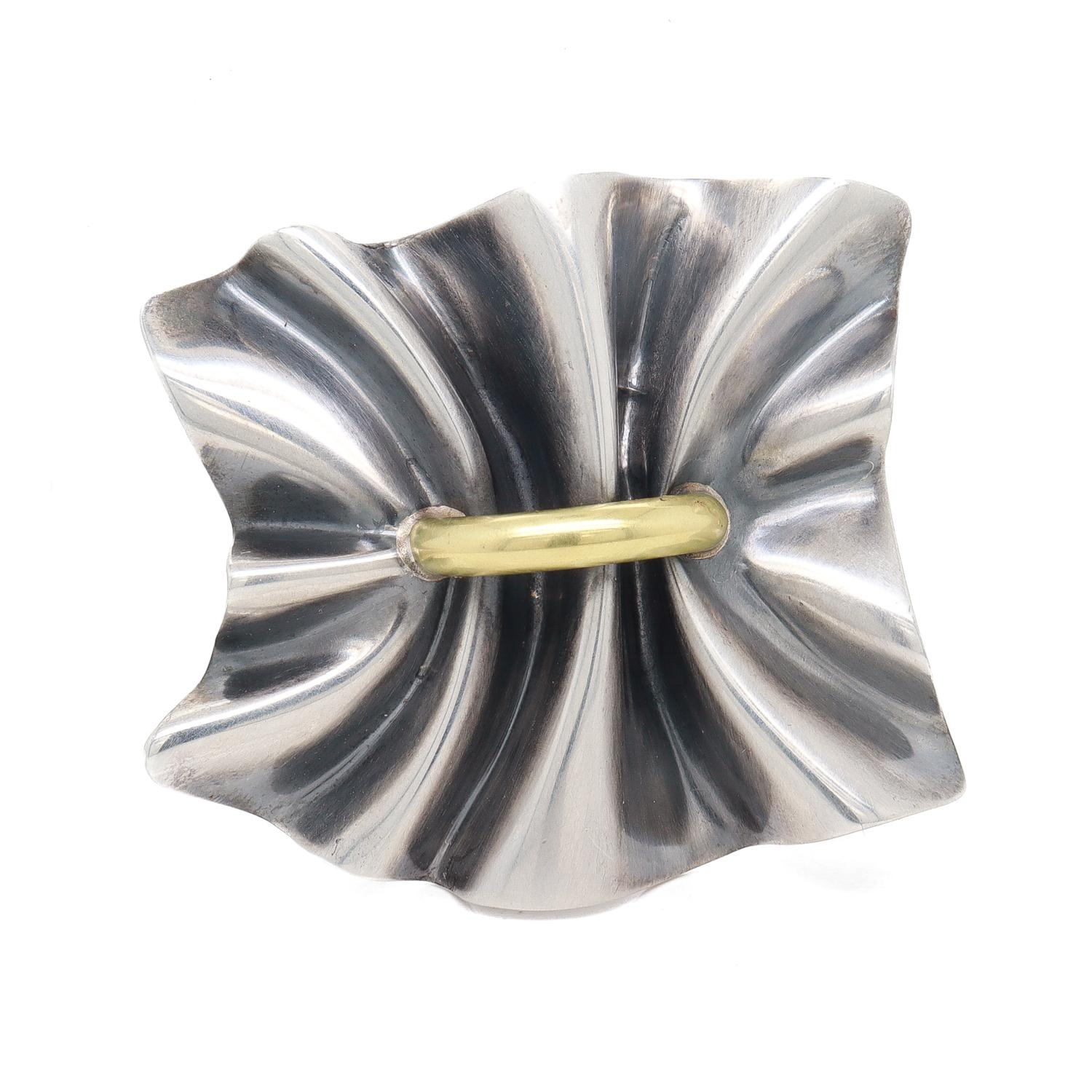 A fine Danish Modern silver & gold brooch.

In sterling silver & 18 karat yellow gold.

Designed by Lene Munthe for Georg Jensen.

Pattern no. 399.

Marked to the reverse with Georg Jensen's maker's mark / 925 S / Denmark / 399.

Together with its