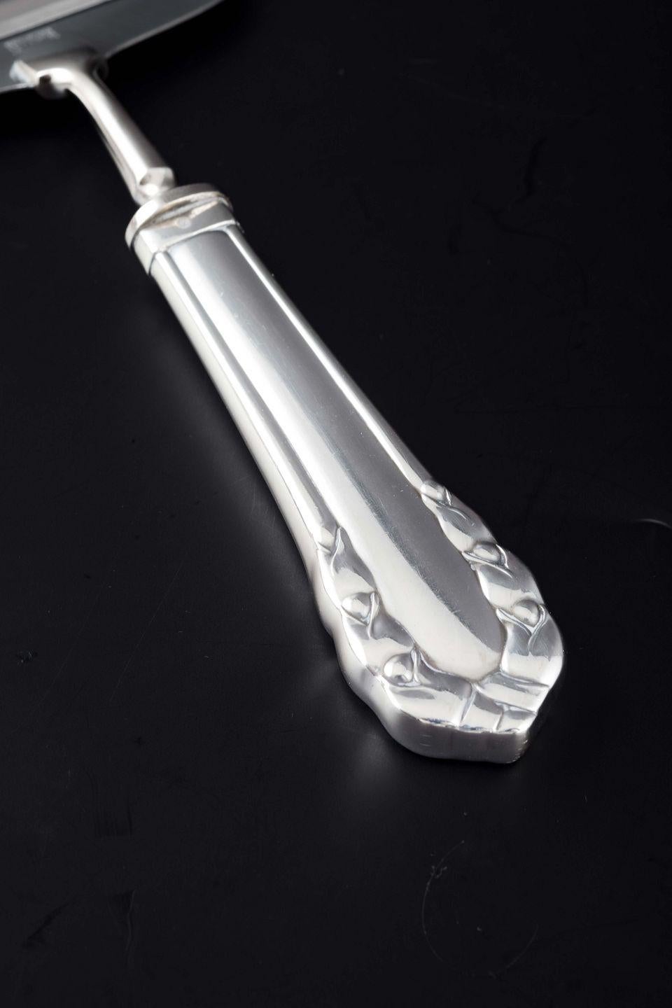 PRE-OWNED GOODS ARE EXEMPT FROM IMPORT TARIFFS FOR U.S., UK, AUSTRALIAN & CANADIAN CUSTOMERS.   
THEREFORE, NO IMPORT TARIFFS WILL BE APPLICABLE TO YOUR PURCHASE. 

Georg Jensen, Denmark.
Cheese slicer in the “Lily of the Valley” pattern.