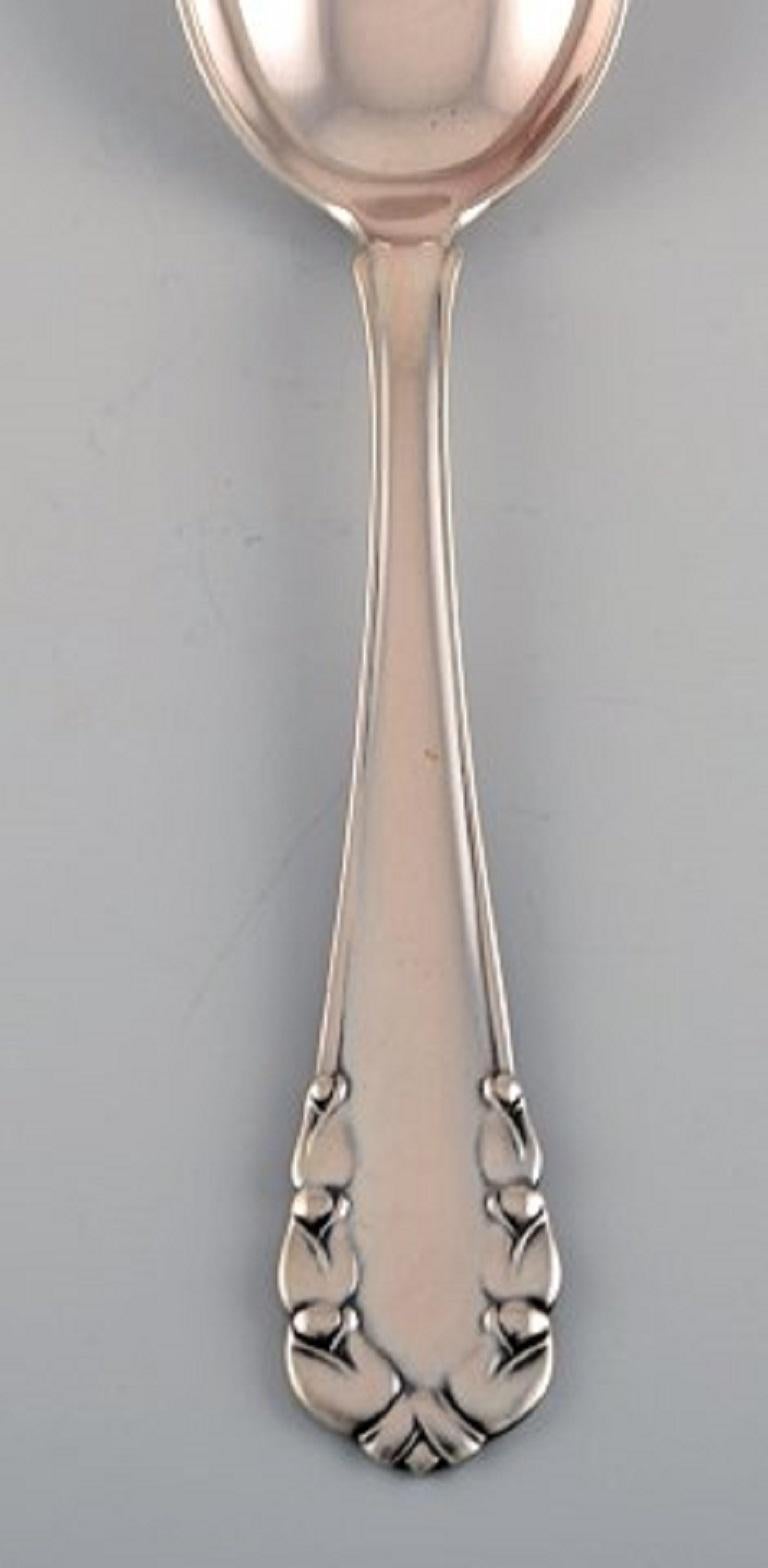 Georg Jensen Lily of the Valley sterling silver dessert spoon. 
There are three spoons available.
Measures: 17.3 cm.
In excellent condition.
Stamped.
Designed by Georg Jensen in 1913.