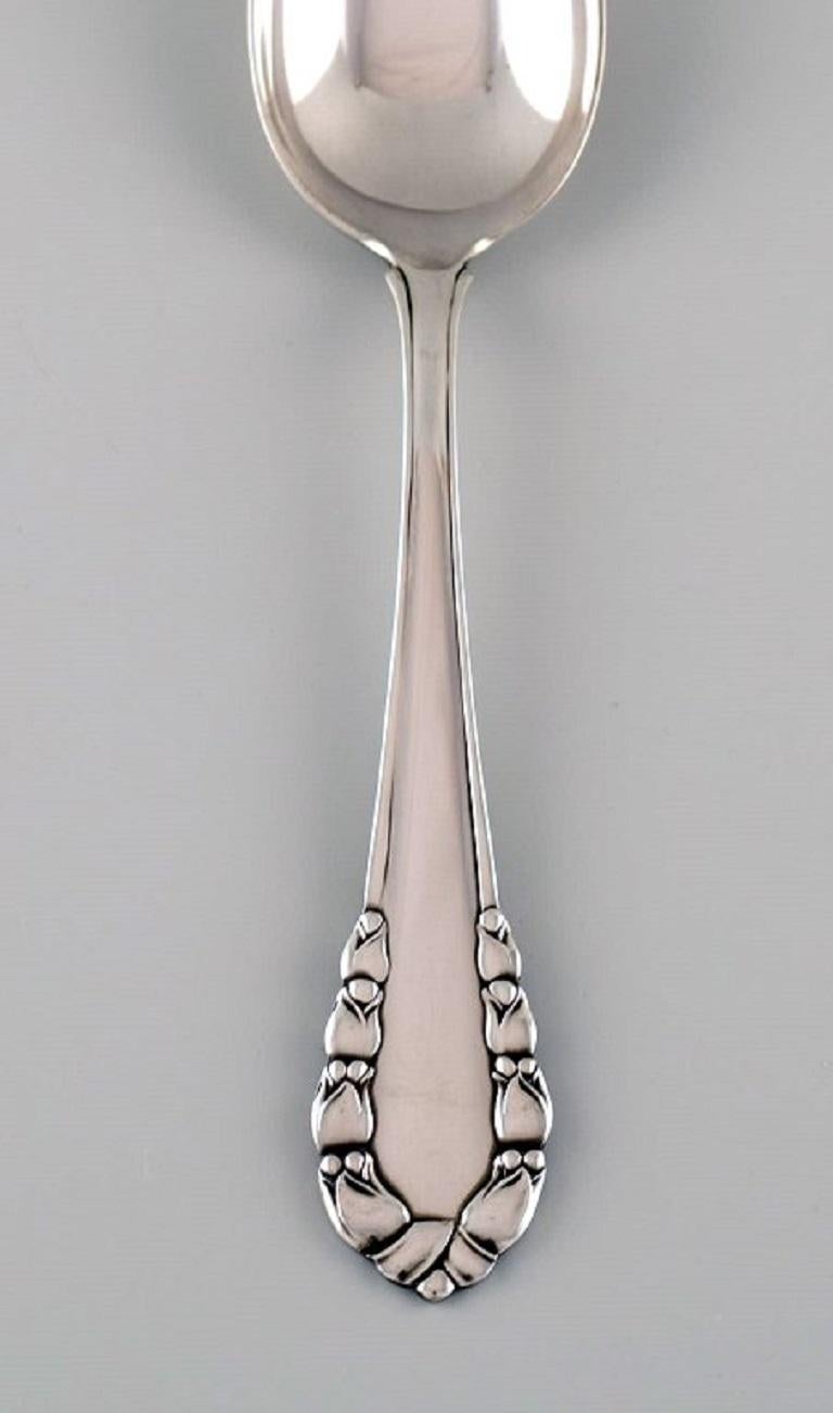 Georg Jensen Lily of the Valley tablespoon in sterling silver. 
Eight spoons are available.
Length: 19.5 cm.
In excellent condition.
Stamped.
Our skilled Georg Jensen silversmith / goldsmith can polish all silver and gold so that it appears