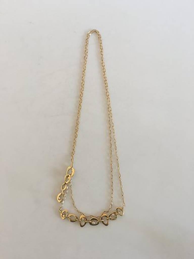 Georg Jensen Lina Falkesgaard 18K Gold Collier ornamented with 10 diamonds (five on each side of the necklace). Measures 112 cm / 44 3/32 in. Chain with adjustable lock. Weighs 28.2 g / 0.99 oz. Marked GJ 750