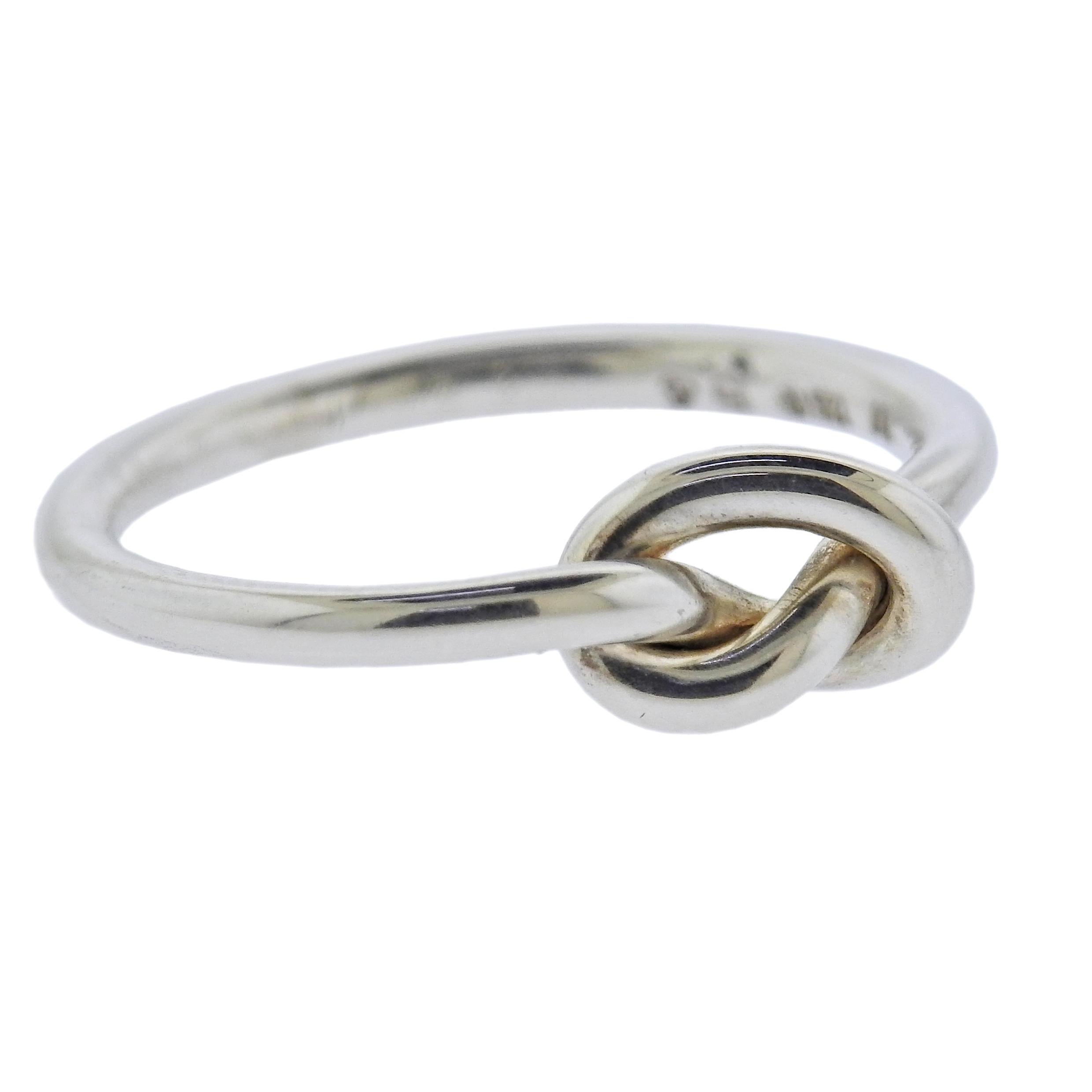 Brand new Georg Jensen sterling silver single Love Knot ring. Knot is 6mm x 9mm.  Ring is available in sizes 53 and 54. Model # 10003871. Marked: GJ 925 S, A44B. Weight - 2.5 grams.