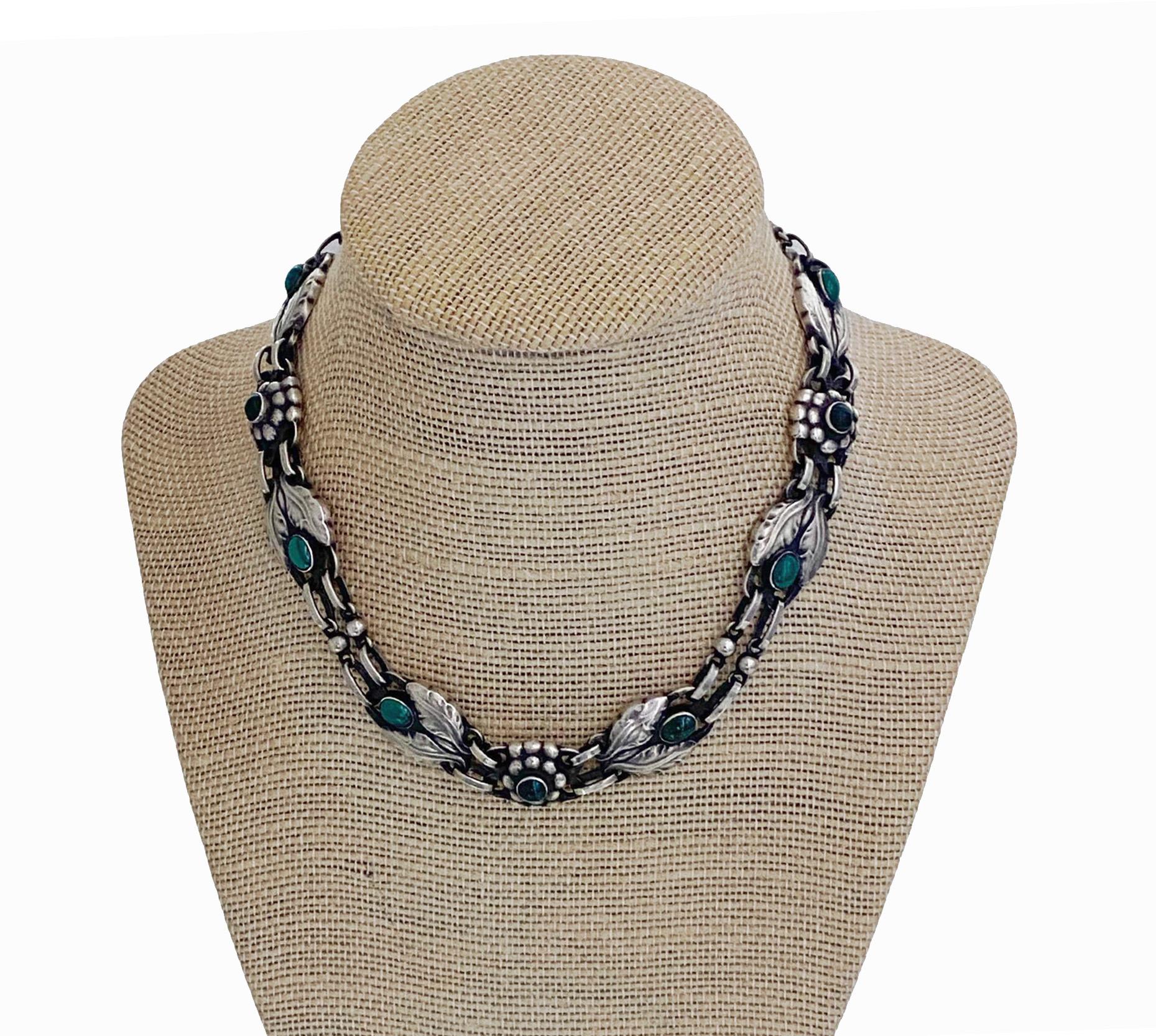 Georg Jensen Malachite and Sterling Silver Necklace No 1, C.1933. Bezel set oval and round malachite with stylised bud leaves and berries interval links. Full Jensen marks and GI marks to reverse. Length14.25 inches. Item Weight: 55.43 grams.