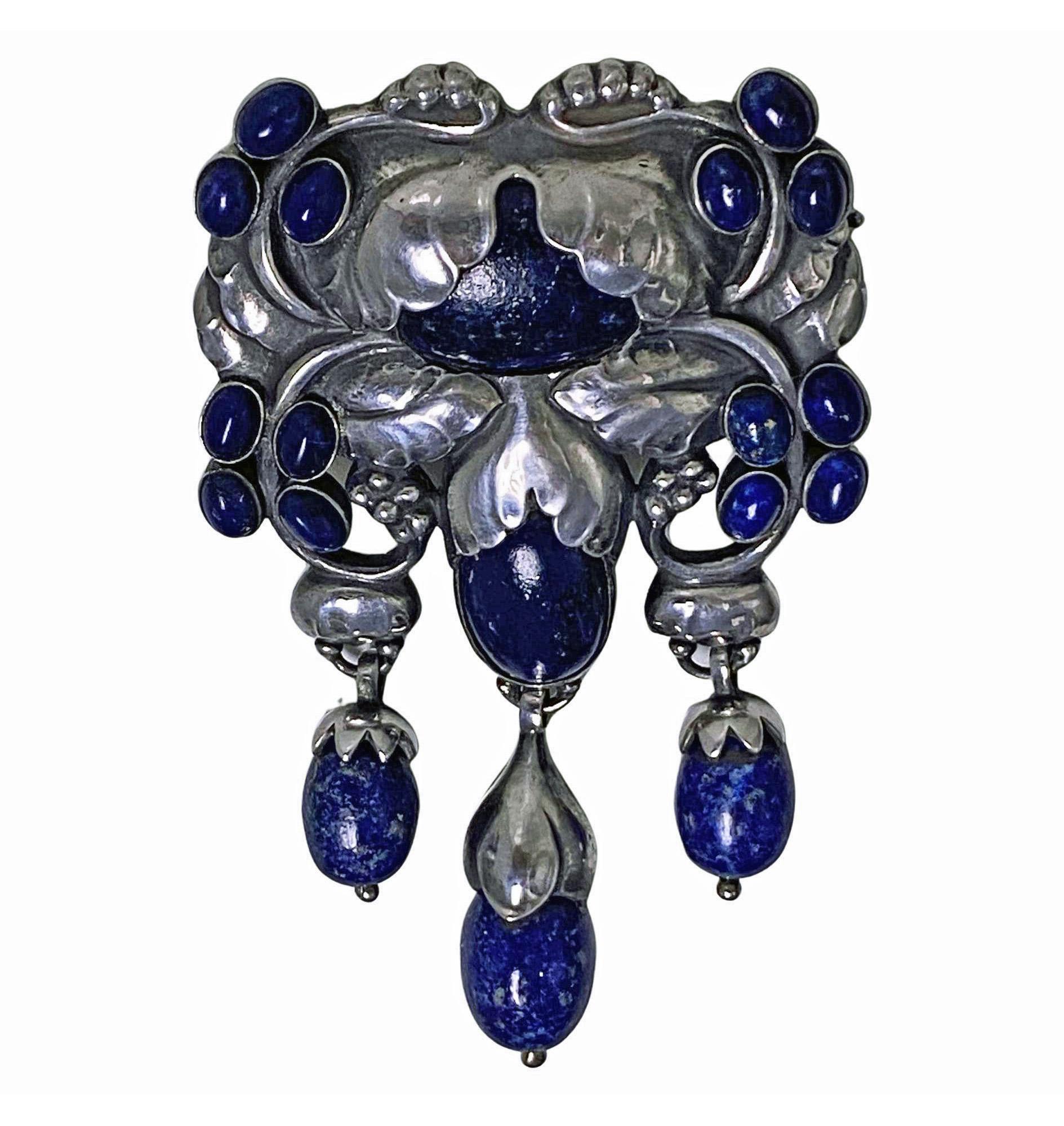 Exceptional Georg Jensen large, rare design Silver and Sodalite Master Brooch, C.1933. Designed as foliate, bud and fruit motifs set with and suspending sodalite cabochons with acorn silver capped drops. Measures: 9.50 x 5.50 cm, 1933-44 marks and
