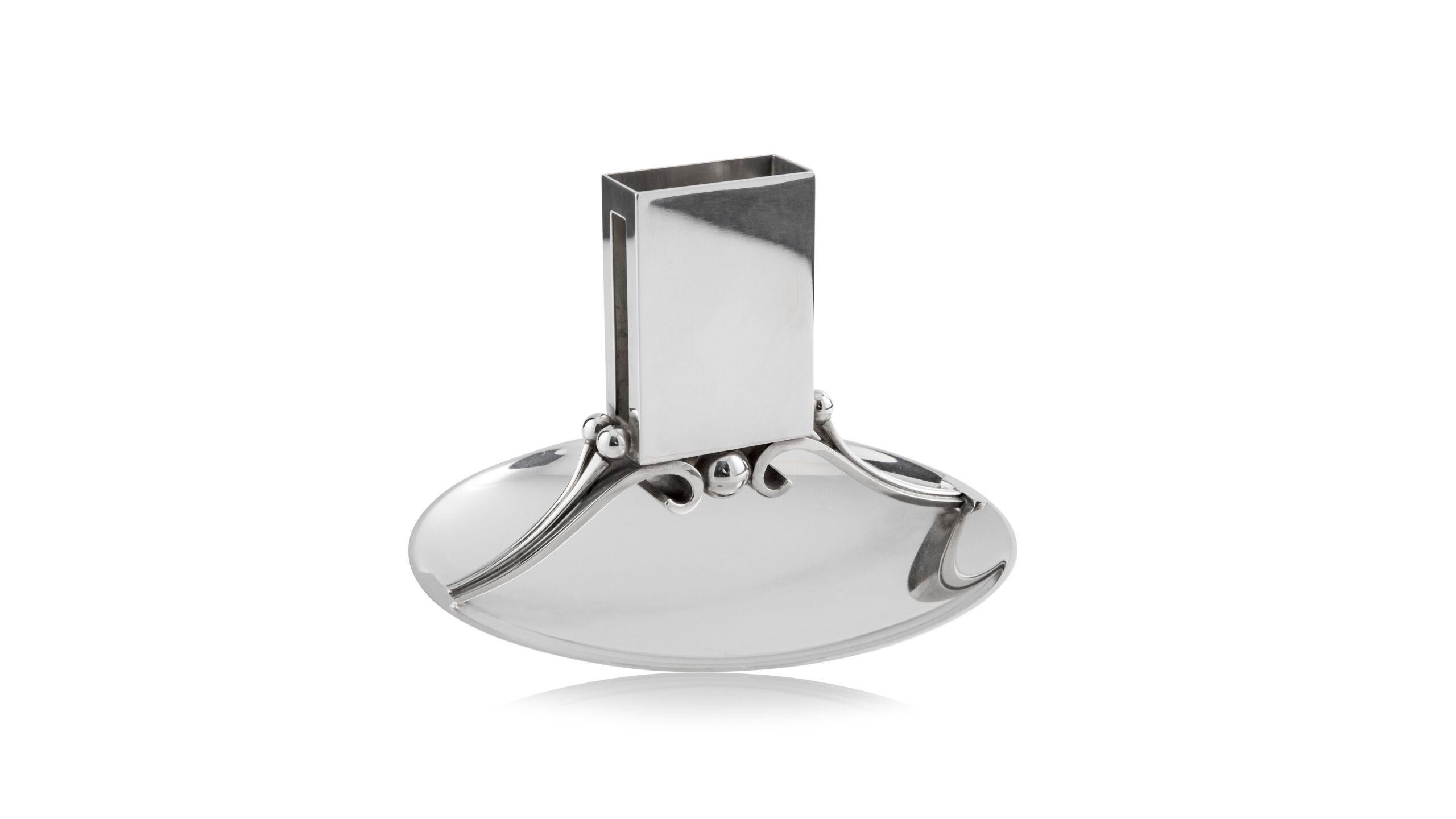 A vintage Georg Jensen sterling silver smoker’s companion in the Art Deco style, design #637B by Harald Nielsen from circa 1931.

Additional information:
Material: Sterling silver
Styles: Art Deco
Hallmarks: With Georg Jensen hallmark and date code