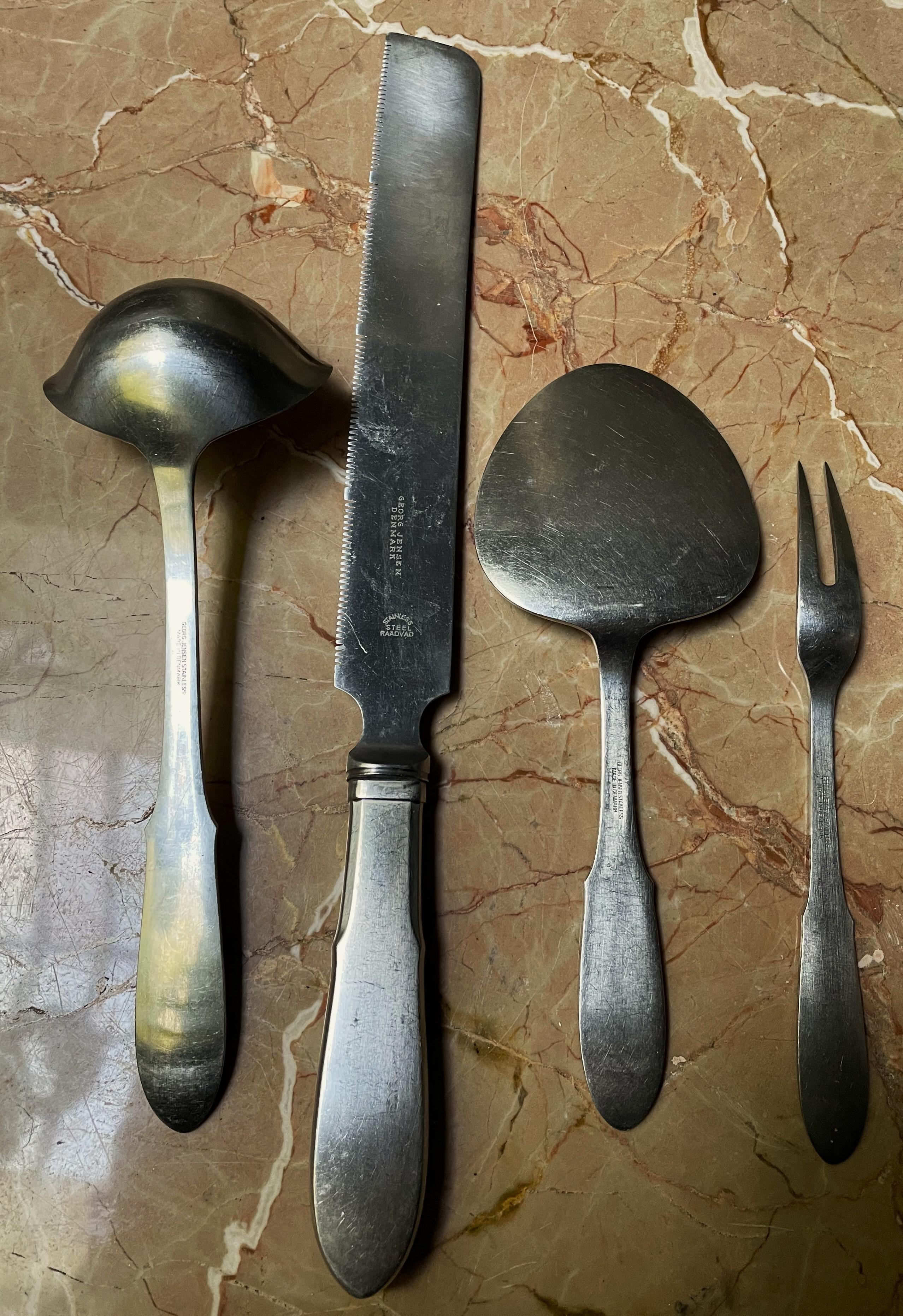 This is a great Georg Jensen stainless steel set of four matching serving pieces in the simple but tasteful, as are all Georg Jensen patterns, Mitra pattern. They have been used and show scratches and signs of wear as shown in the photos but they