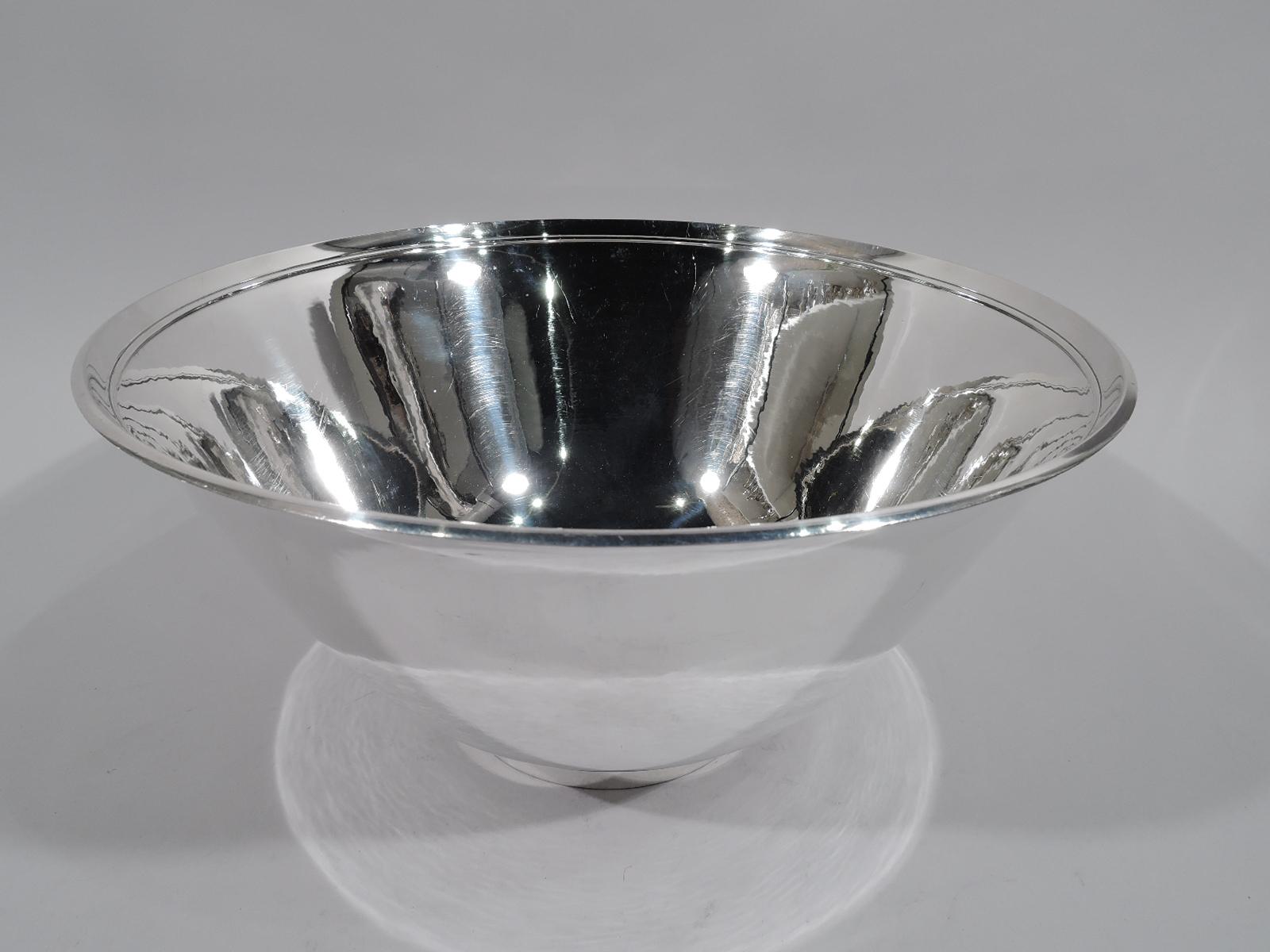 Large and modern sterling silver centerpiece bowl with beautiful hand hammering. Made by Georg Jensen in Copenhagen. Conical with raised and inset round foot. Spare with raised interior rim band based on design by Harald Nielsen. Postwar hallmark