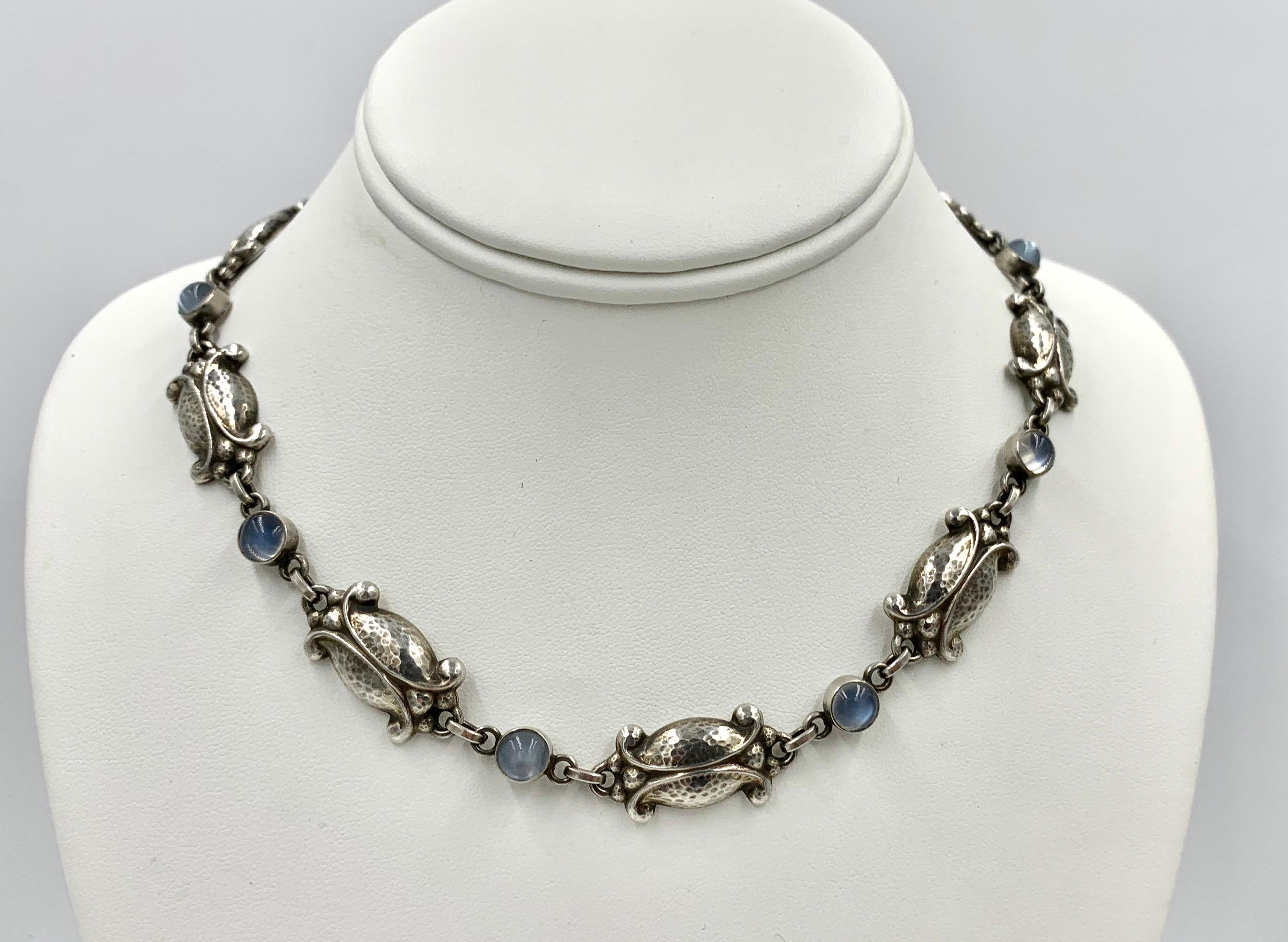 Georg Jensen Vintage Moonlight Blossom Sterling Silver Necklace No. 15 with Moonstones.  16.5 inches long.

This is a gorgeous example of a necklace that can be worn day or evening.   The Moonstone Moonlight Blossom Necklace has beautiful patina on