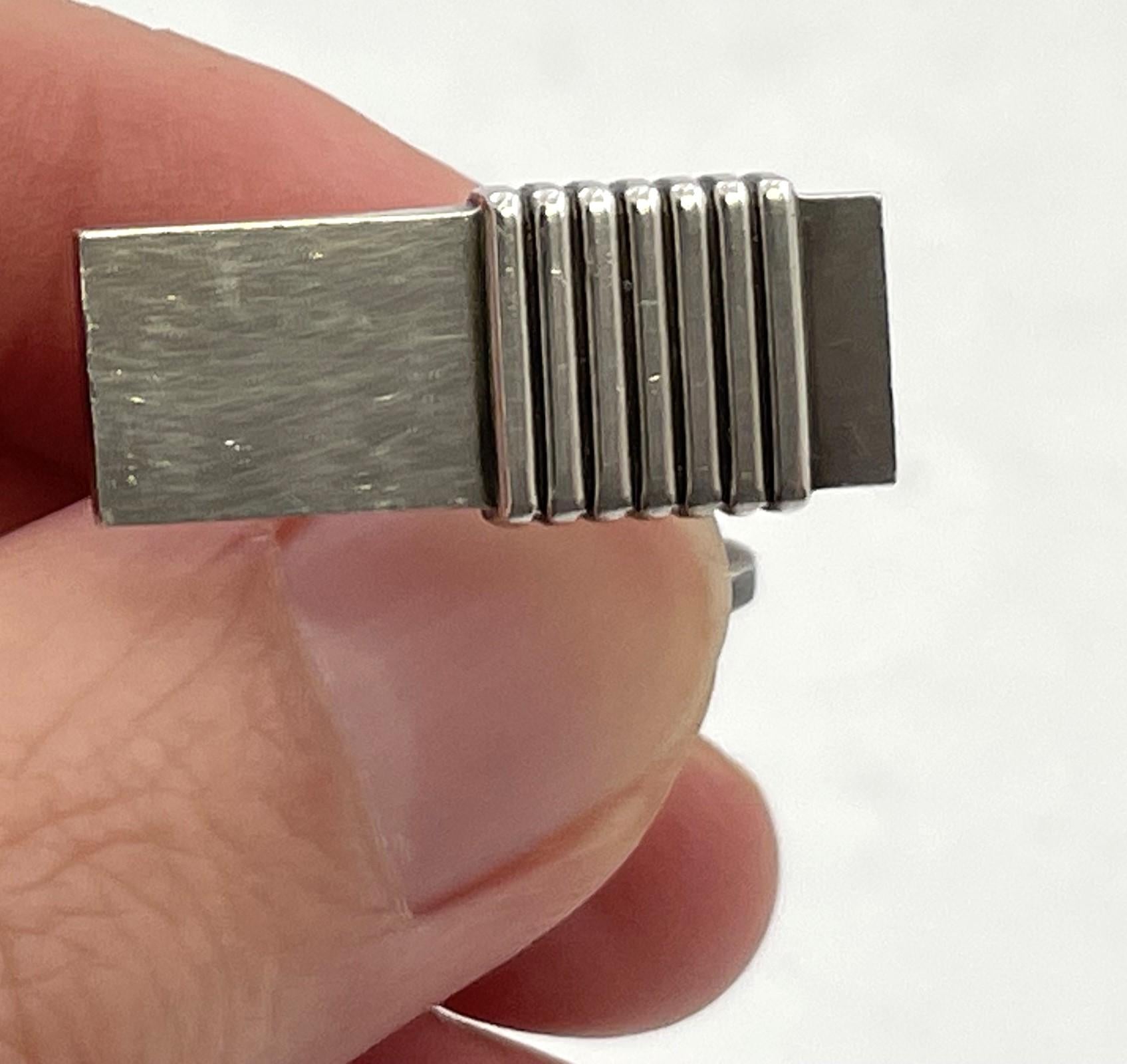 Pair of Georg Jensen sterling silver cufflinks, in pattern number 80, in an elegant, geometric design. They measure 7/8'' by 1/3'' by 7/8'' in depth, and bear hallmarks as shown. 

Danish silversmith Georg Jensen (1866-1935) set up his own silver