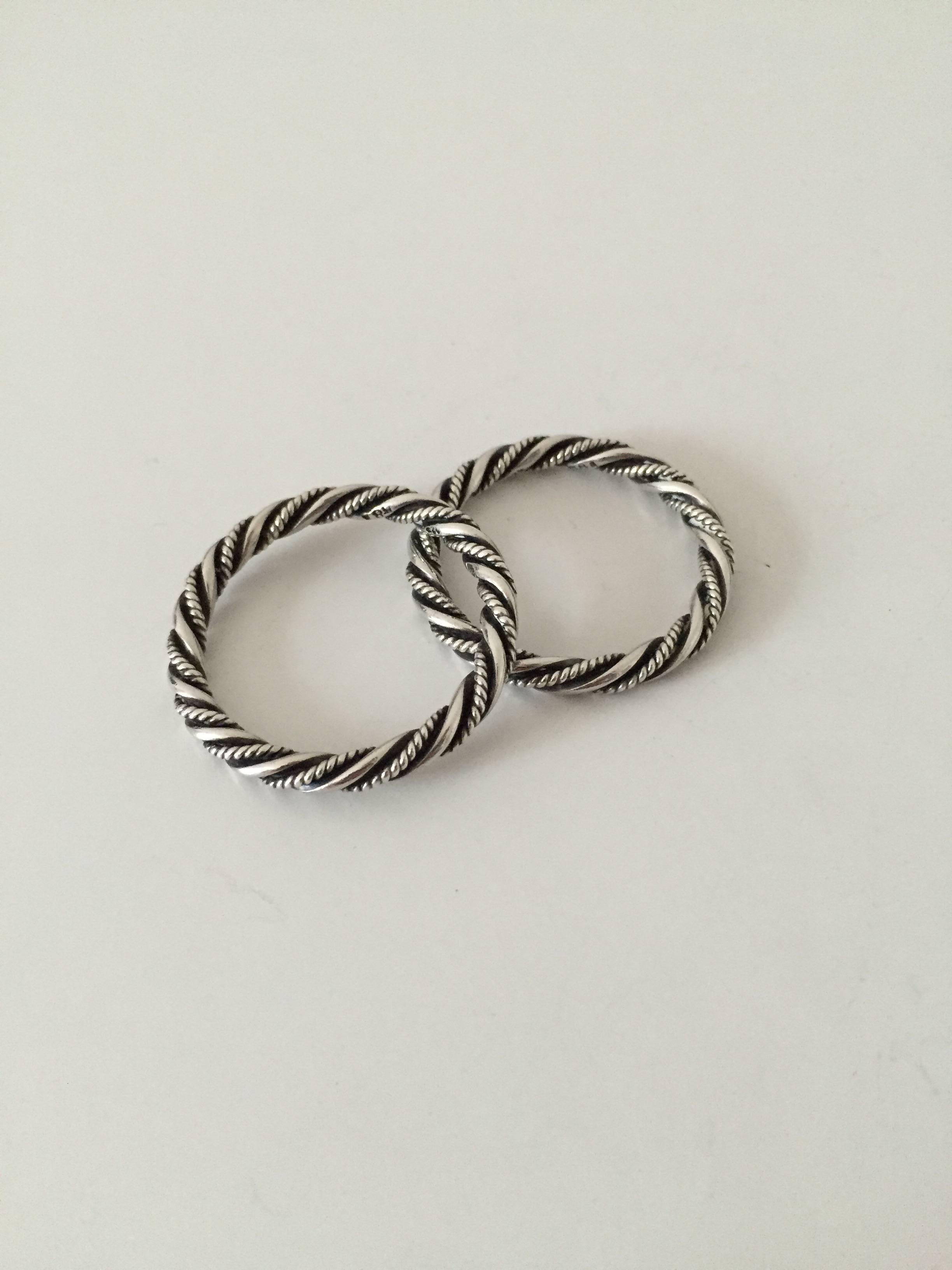 Georg Jensen pair of rings in sterling silver #58A. We are not sure of their use, but think of them as perfect as a little napkinring

Measures 3.5 cm (1 3/8