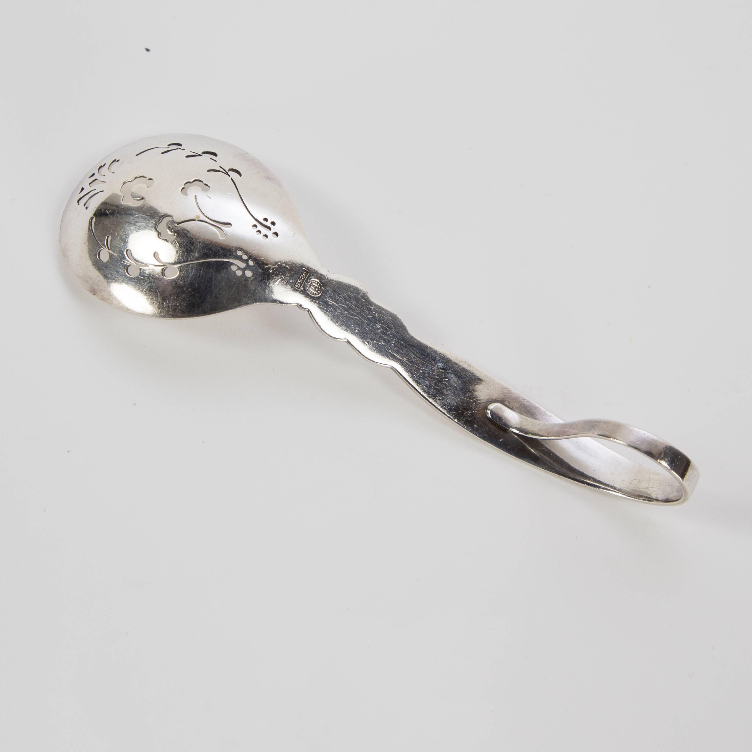 Georg Jensen sterling silver pierced serving berry spoon with curved handle; cactus pattern; Copenhagen, Denmark, circa 1930s; measure: approx. 5.5” long x CH YD $395.
 