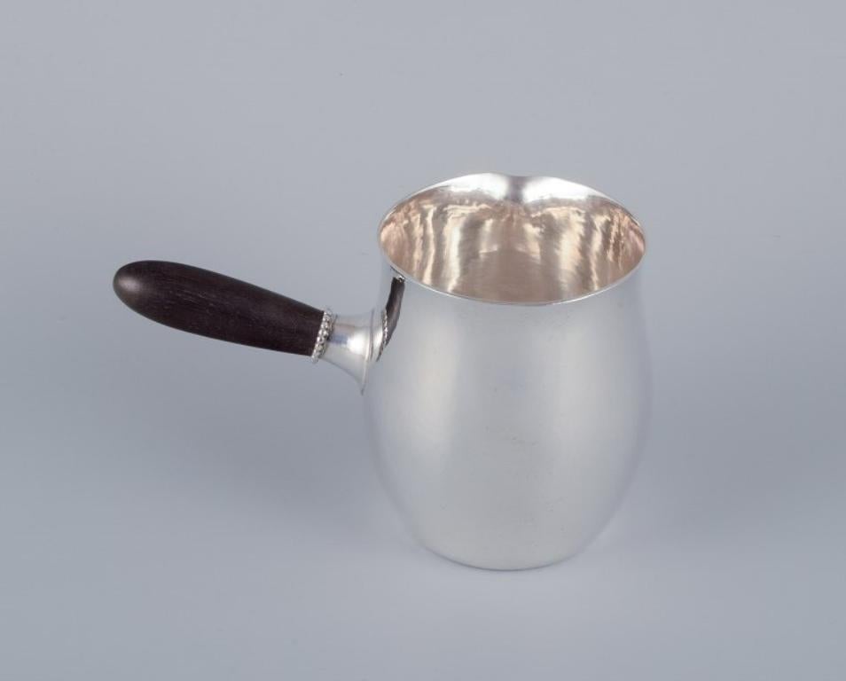 Danish Georg Jensen pitcher in sterling silver with an ebony handle. Model 80A.  For Sale
