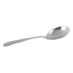 Georg Jensen "Rope" serving spoon in sterling silver.
