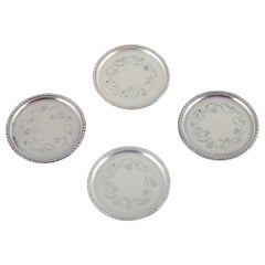 Georg Jensen, set of four glass coasters in sterling silver.