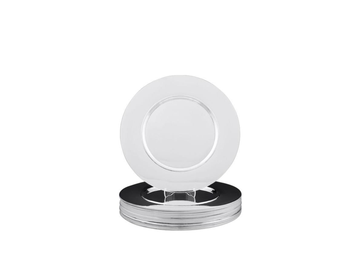 A set of twelve early sterling silver Georg Jensen charger plates, design #587A by Johan Rohde (1930). This minimalist design marks Rohde’s transition from Art Nouveau to Art Deco, showcasing understated elegance with the classic Georg Jensen