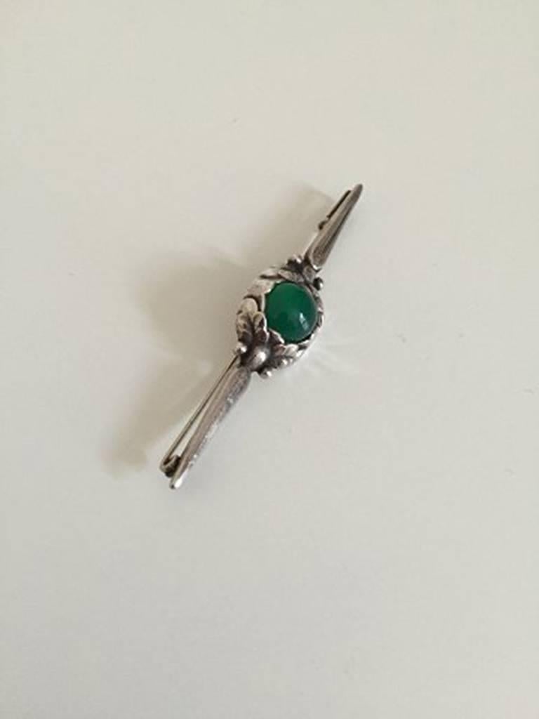 Georg Jensen Silver Brooch Green Agate #117 from 1910-1920.  Measures 7,3cm (2 7/8 in.) and is in good condition. Weighs 6,2g / 0,21oz