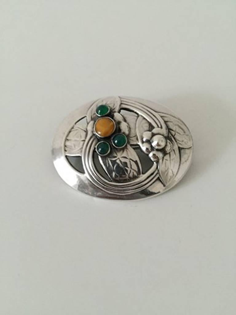 Georg Jensen Silver Brooch with Amber and Green Stones #13 From 1904-1914.  Measures 5cm x 3.9cm (1 31/32 in. x 1 17/32 in). Weighs 11g / 0,35oz