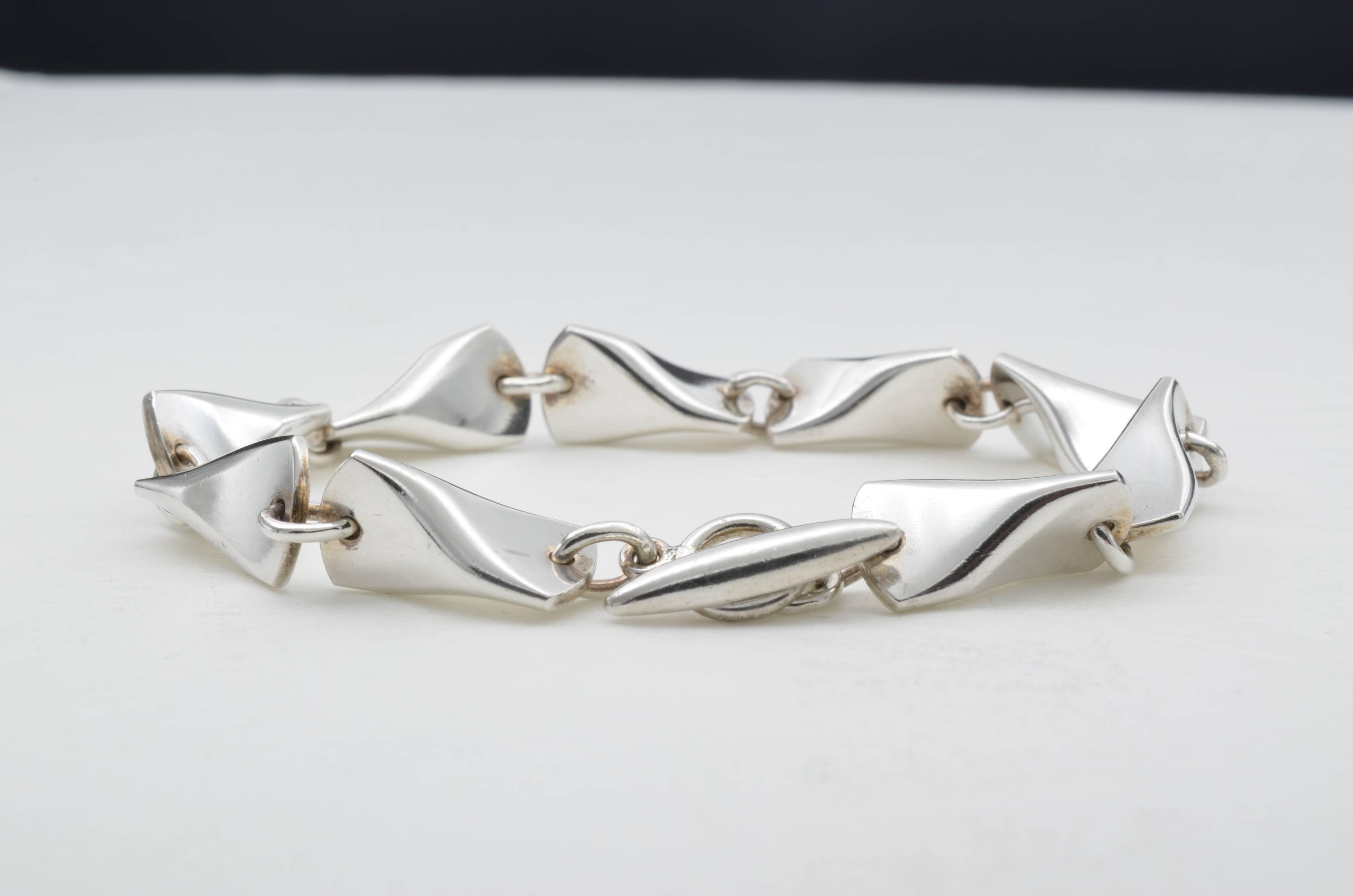 This beautiful Georg Jensen bracelet is a classic, designed in 1955 by Tove and Edvard Kindt-Larsen. Comprised of seven 