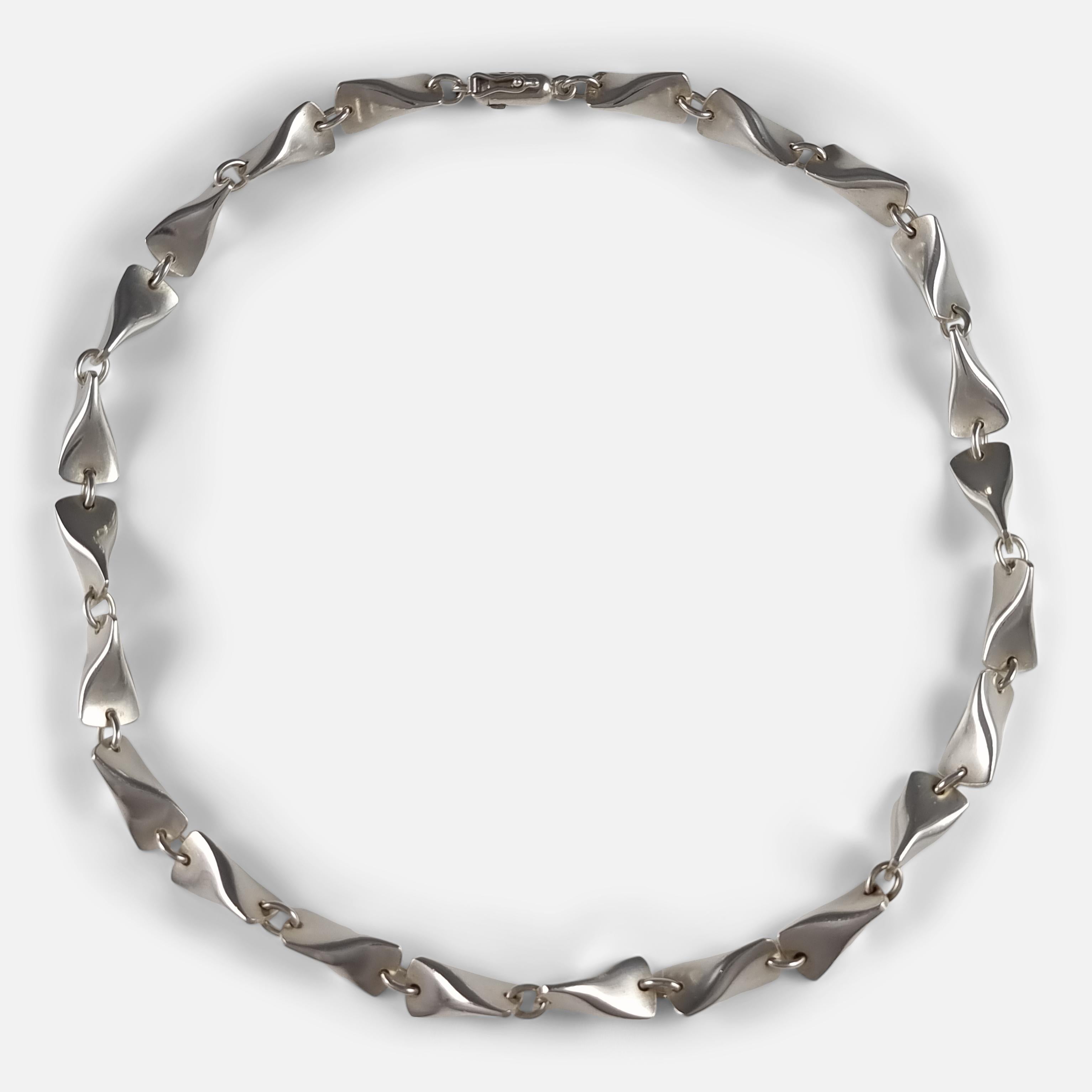 A Georg Jensen sterling silver 'Butterfly' Necklace #104A, by Edvard Kindt-Larsen. It features the distinctive Georg Jensen makers mark, stamped with 'Sterling Denmark', '104A', and London import marks for 1960.

• Measurement: Inner circumference: