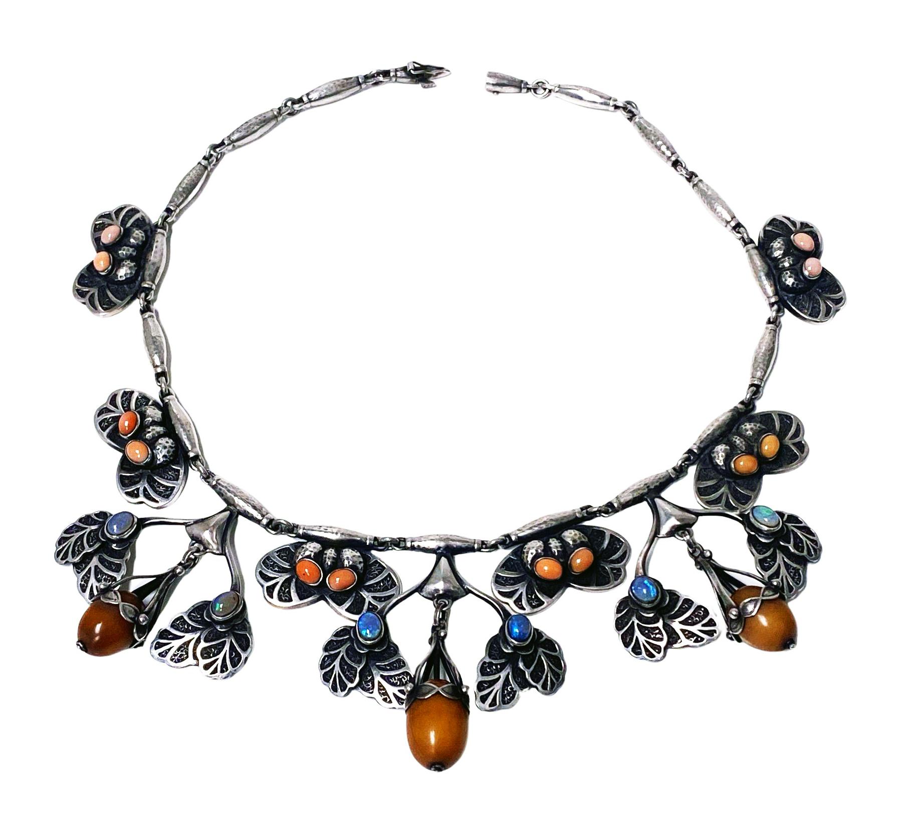 Georg Jensen exceptionally rare No 4 Necklace C.1915. The foliate links with oxidized stippled background against polished silver each bezel set with pairs of oval coral colour cabochons, interspaced with larger drops of opals, and set with amber
