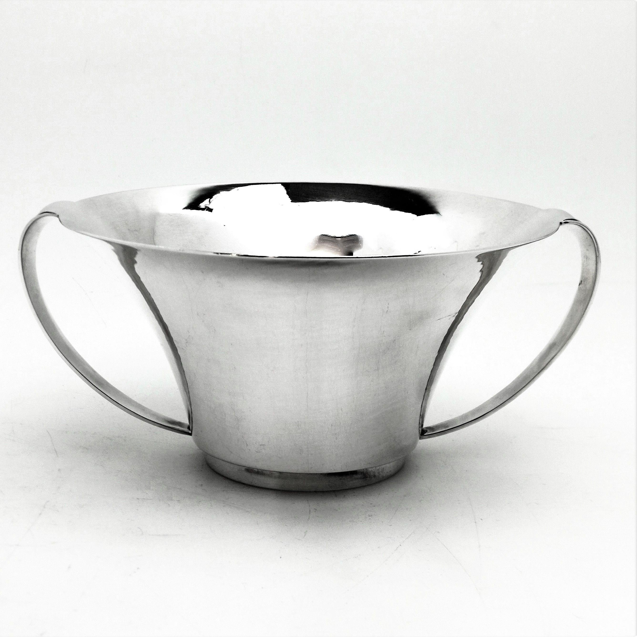 A beautiful Danish Solid Silver two handled Bowl by Georg Jensen. This Silver Bowl has an elegant everted body with a flared lip and a pair of simple curved handles. 
 
 Made in Denmark in circa 1945-1977 by Georg Jensen.
 
 Approx. Weight - 8.9oz /
