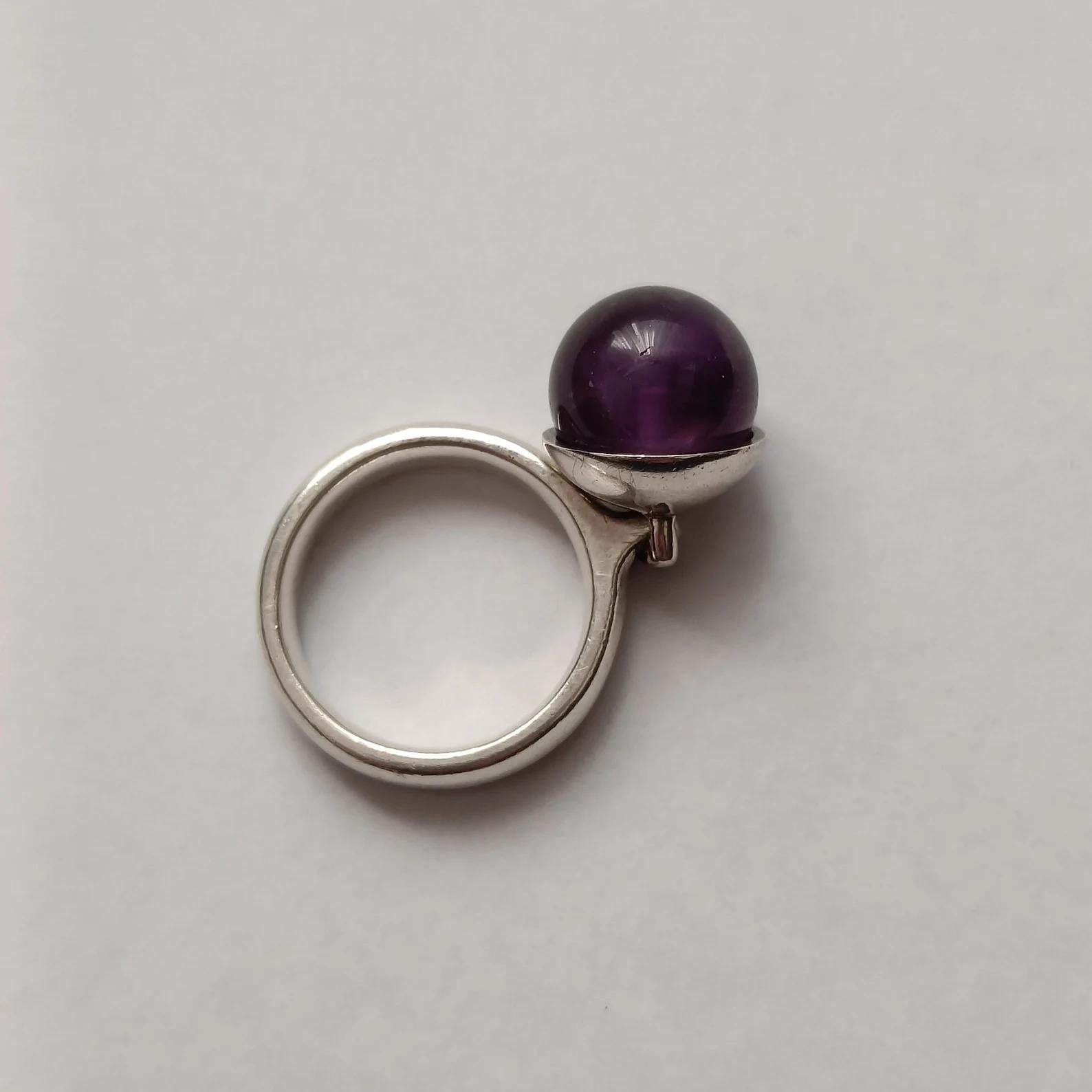 Unusual silver ring with an Amethyst sphere mounted on a movable pendant. Designed by Regitze Overgaard for Georg Jensen, model 473A. Part of 