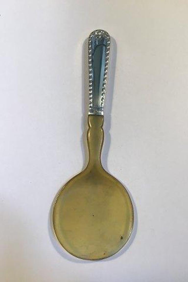 Server in corda d'argento Georg Jensen con corno n. 159.

Misura 20 cm/7,87 pollici.