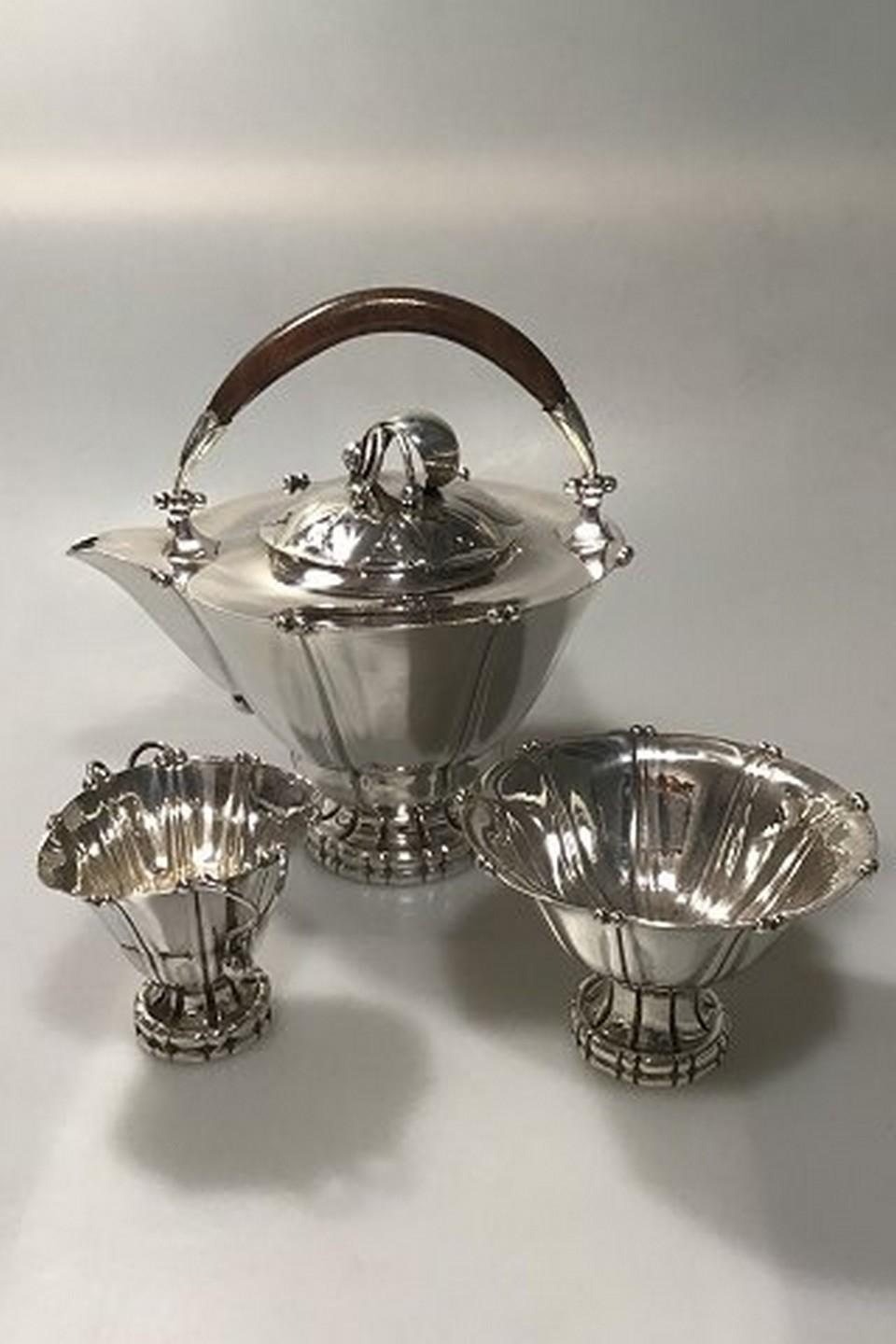 Georg Jensen silver/sterling silver tea set no. 4
Creamer no 4 (1915-1927) measures 8 cm (3 5/32 in) weight 96.9 gr/3.42 oz
Sugar bowl no 4 measures: height 8 cm (3 5/32 in) diameter 12 cm (4 23/32 in) weight 136.8 gr/ 4.83 oz
Tea pot no 4C.