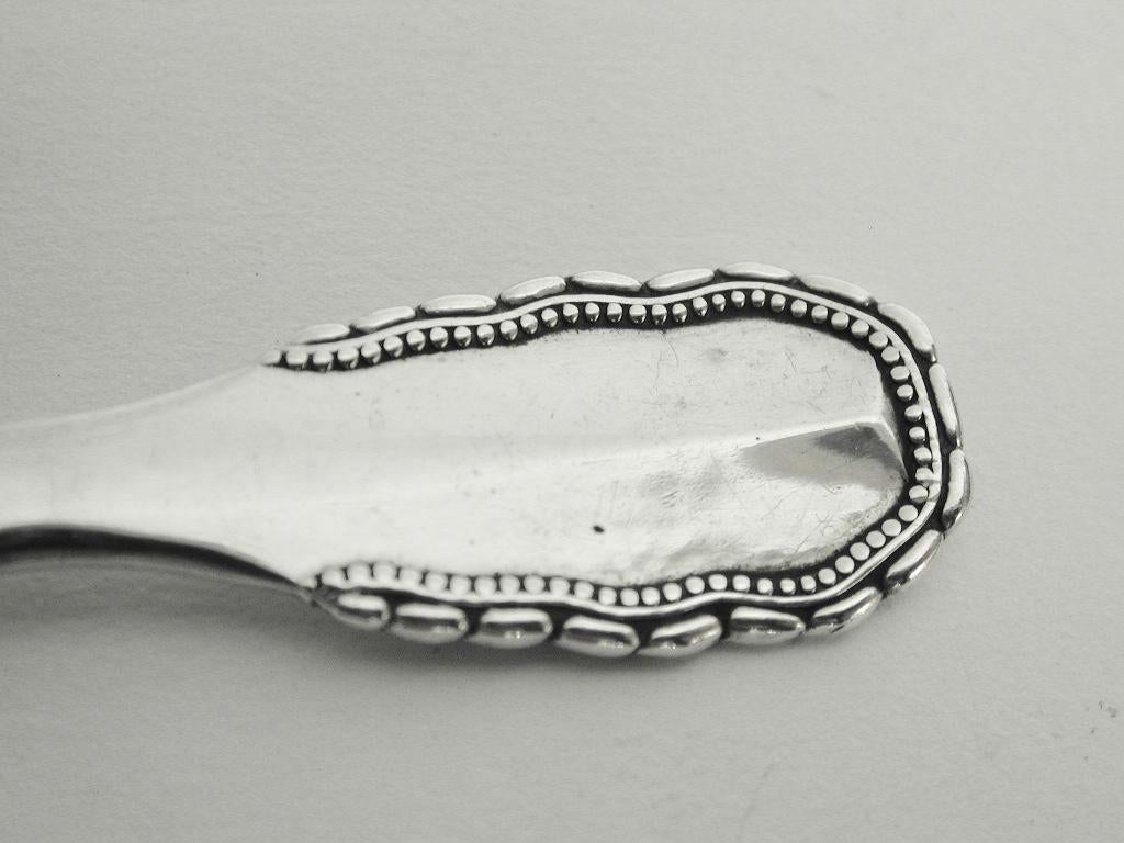 Georg Jensen silver viking pattern tea caddy spoon, dated Circa 1930
This heavy spoon has light hand hammering all over.
The silver content is 83 percent, hence the hallmark 830s which finished in 1930.
 
