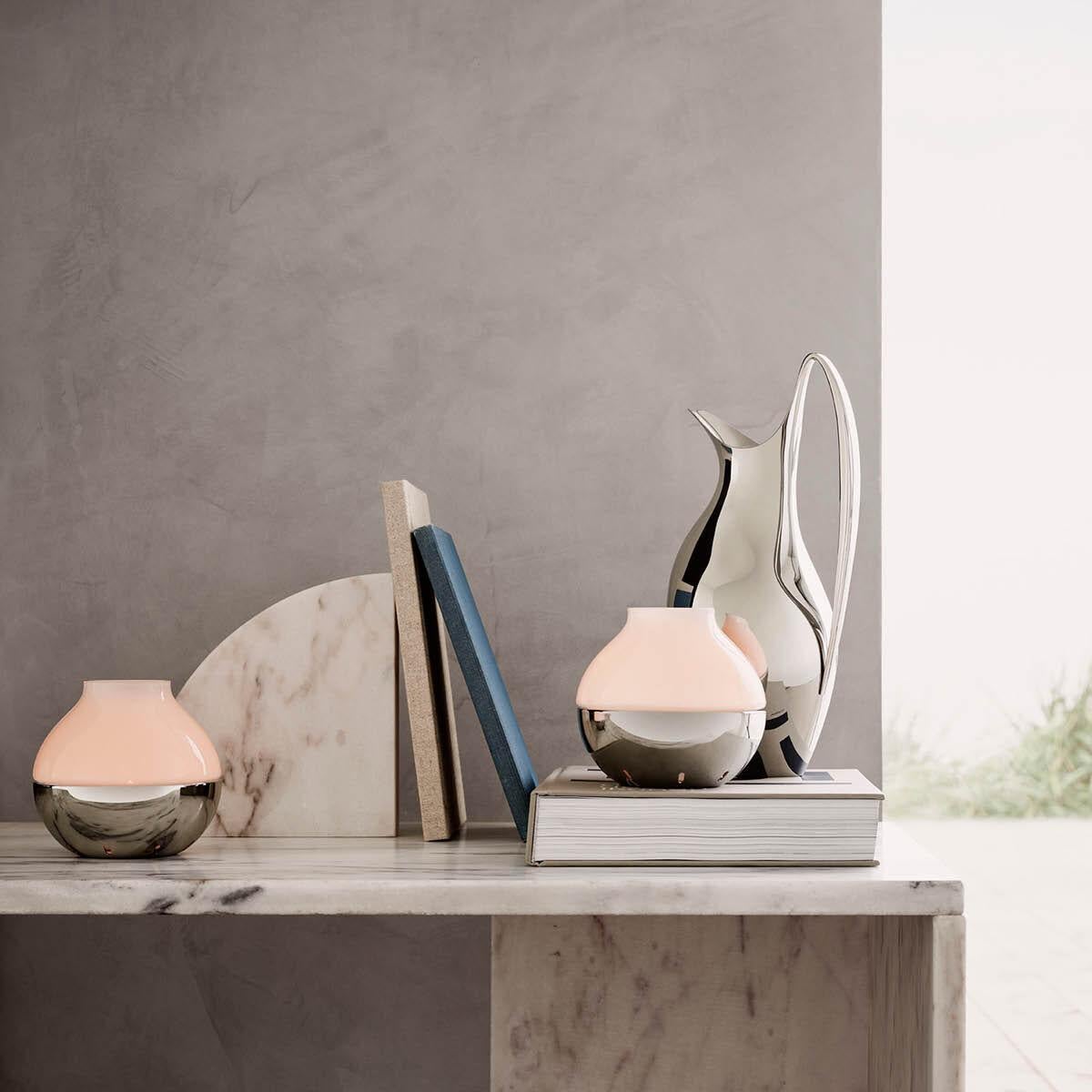 Inspired by original Henning Koppel pieces, this beautiful frosted glass and stainless steel hurricane candleholder for use with tea-lights is a perfect example of form and functionality. The elegant shape contrasts the two very different materials