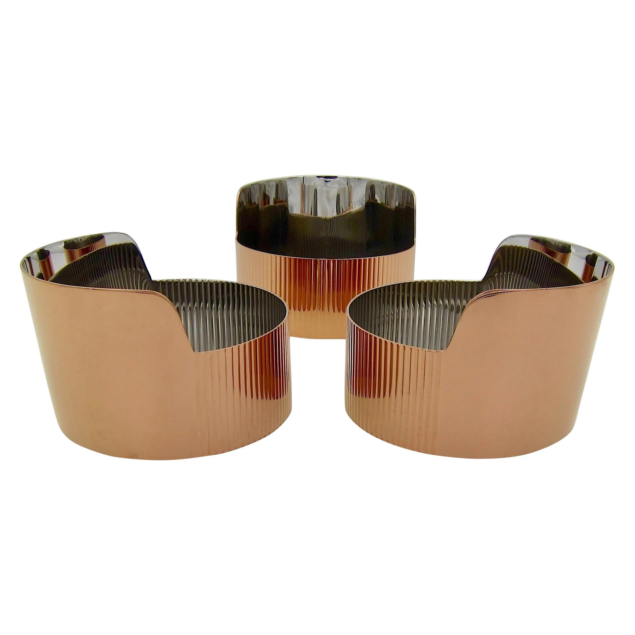 A set of three matching Georg Jensen snack or trinket bowls in stainless steel with a warm and reflective copper-colored and scratch-resistant PVD coating. The sleek Art Deco-inspired Urkiola Collection was a successful 2016 collaboration between