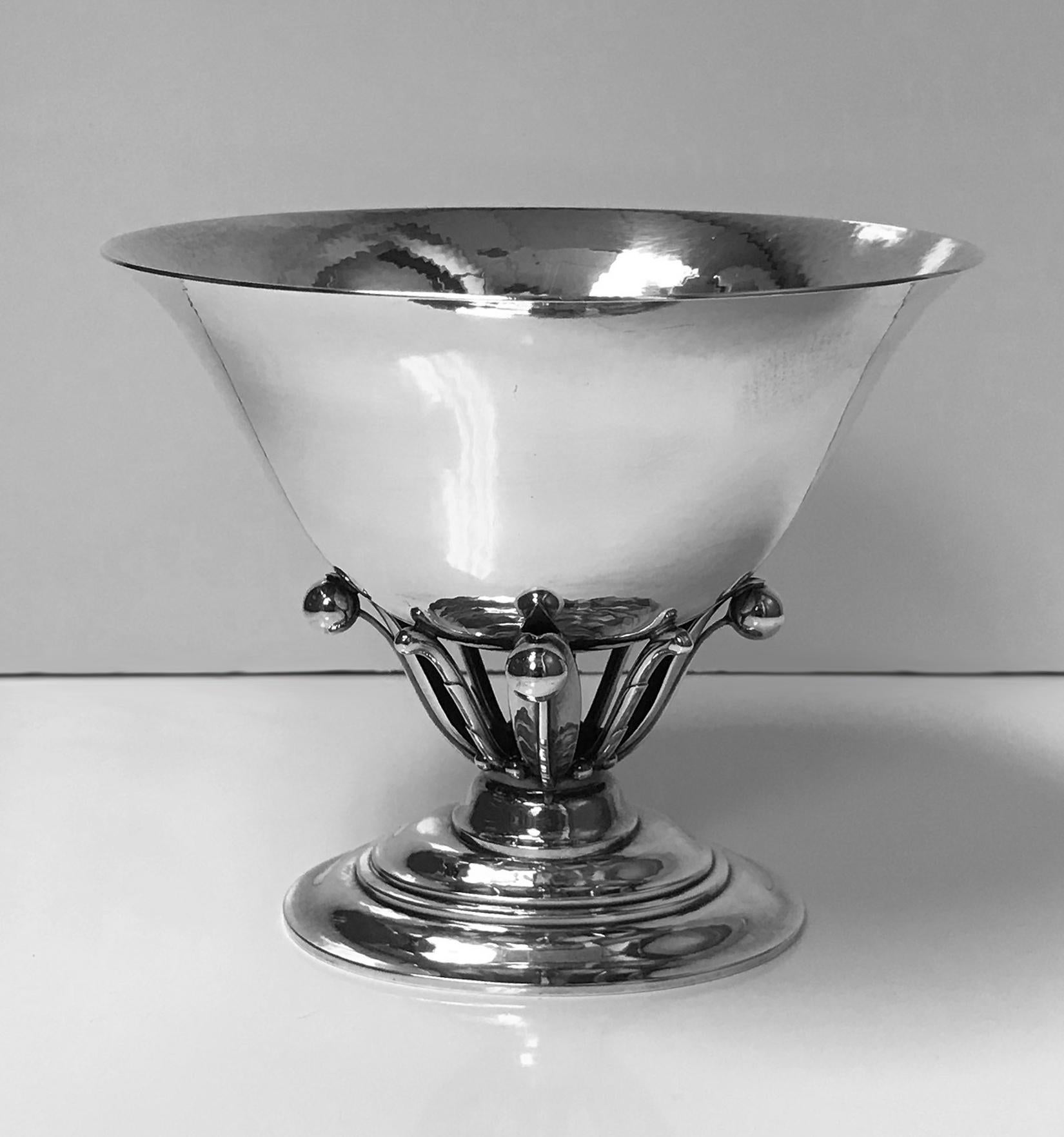 Georg Jensen sterling bowl no. 6, designed by Johan Rohde initially in 1912. The bowl on stepped oval base with bud and leaf foliate supports for plain slightly everted and tapered hammered finish bowl. Marks for Georg Jensen post 1945. Measures: