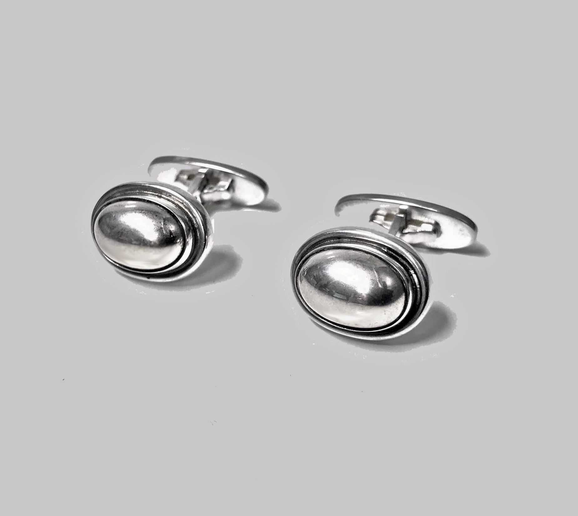 Georg Jensen oval cufflinks, #44B. Sterling oval dome cufflinks with silver bezel surround design #44B by Harald Nielsen. Size: 16.70 x 12.70 mm. Total item weight: 13.90 gm.