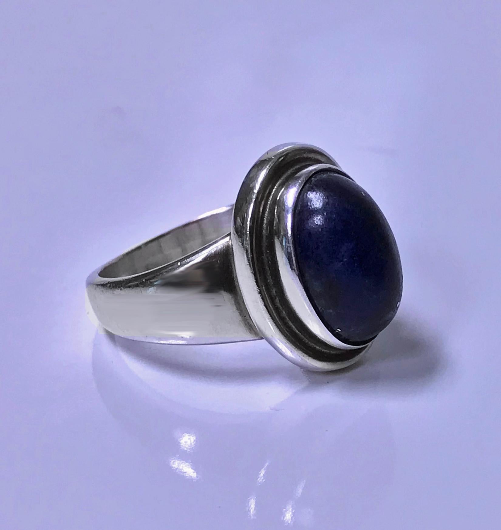 Georg Jensen Sterling Lapis Ring, designed by Harald Nielsen.The Ring bezel set with oval lapis lazuli.Full Georg Jensen marks to underside, post 1945, Denmark 46 B. Item Weight: 6.92 gm. Ring Size: 7.25.